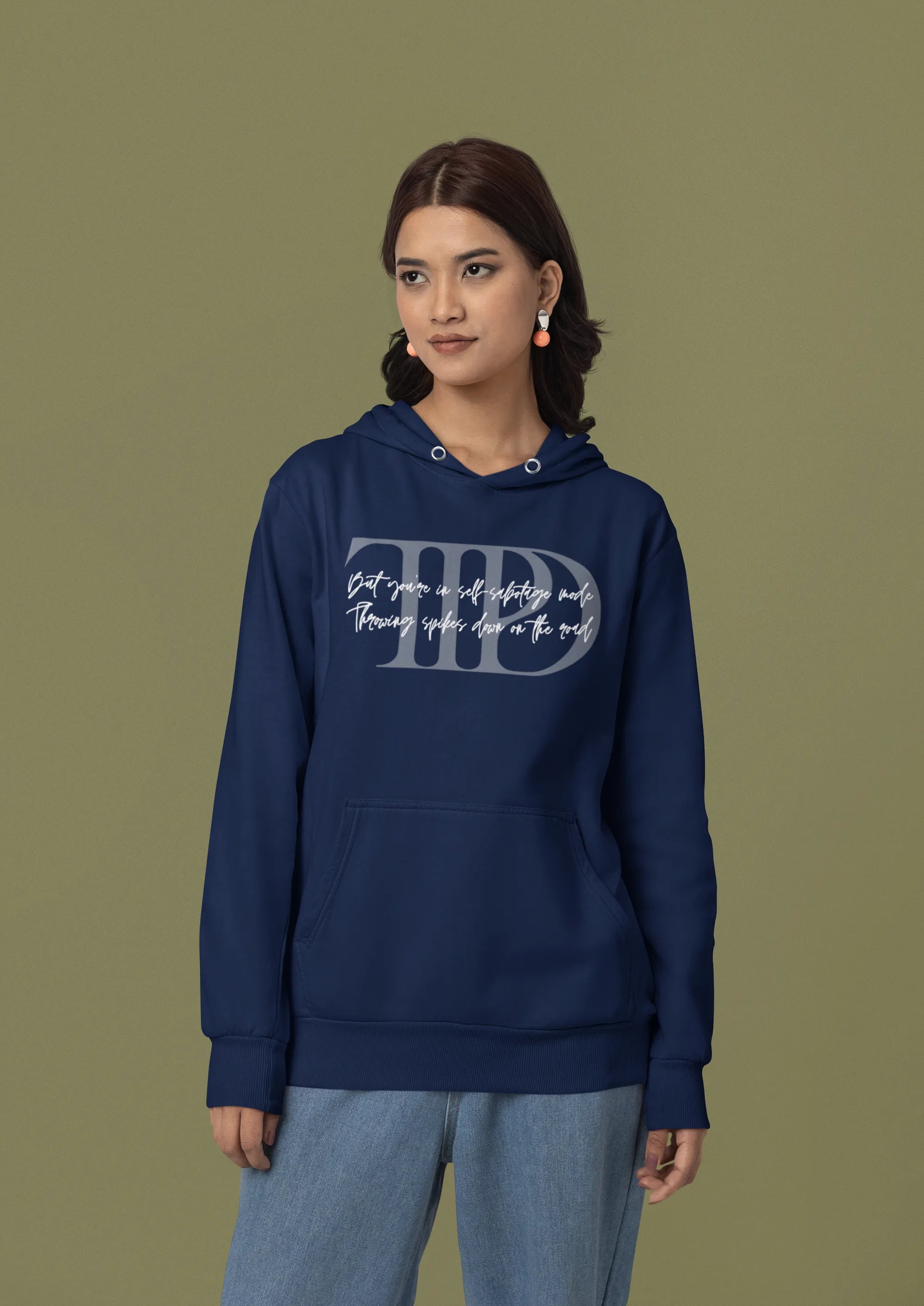 First front view of a female model wearing a navy blue oversized, cozy hoodie featuring "Lamenting" lyrics from Taylor Swift's TTPD era. Perfect for Swifties looking for comfortable Eras Tour merch.