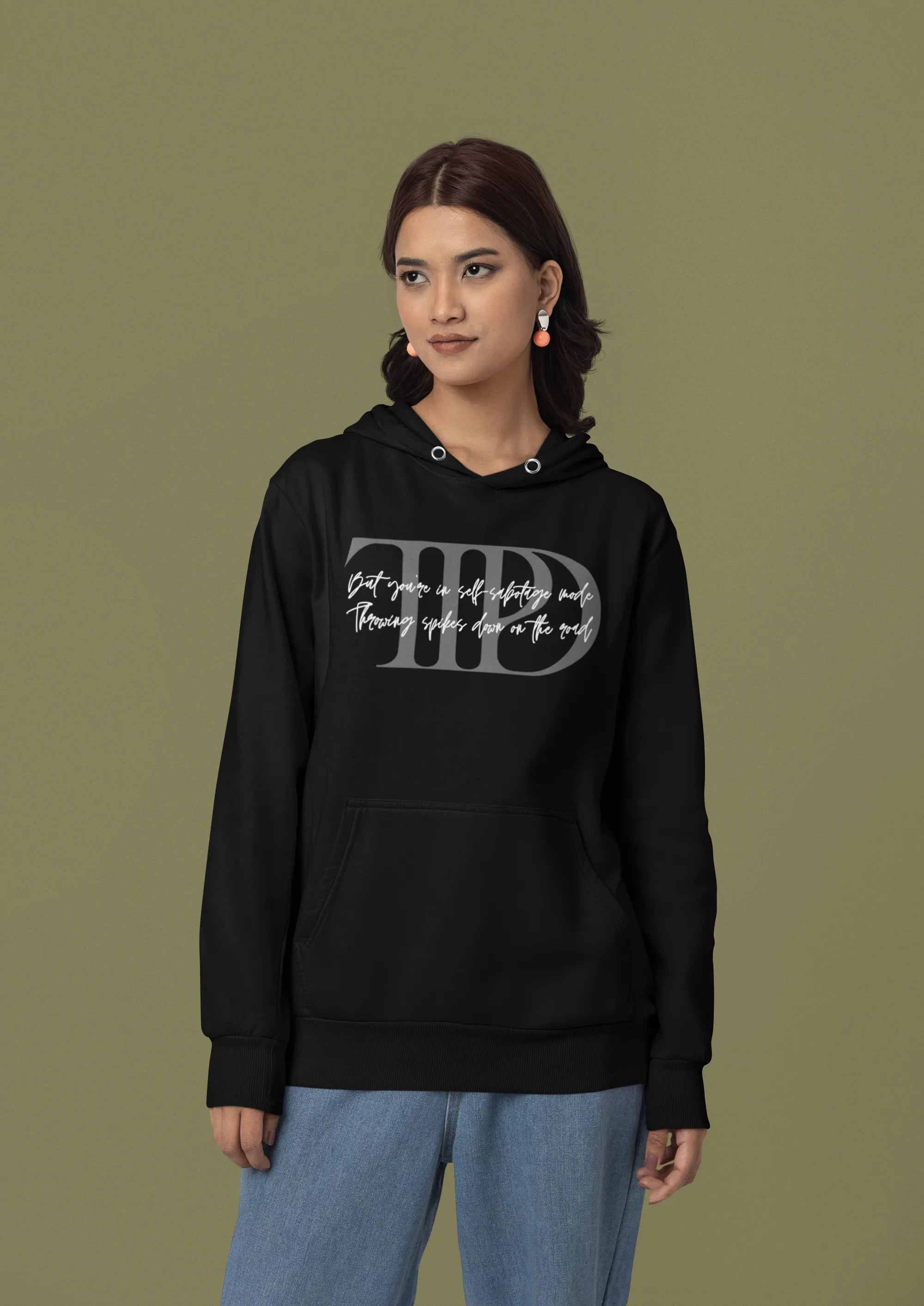 First front view of a female model wearing a black oversized, cozy hoodie featuring "Lamenting" lyrics from Taylor Swift's TTPD era. Perfect for Swifties looking for comfortable Eras Tour merch.