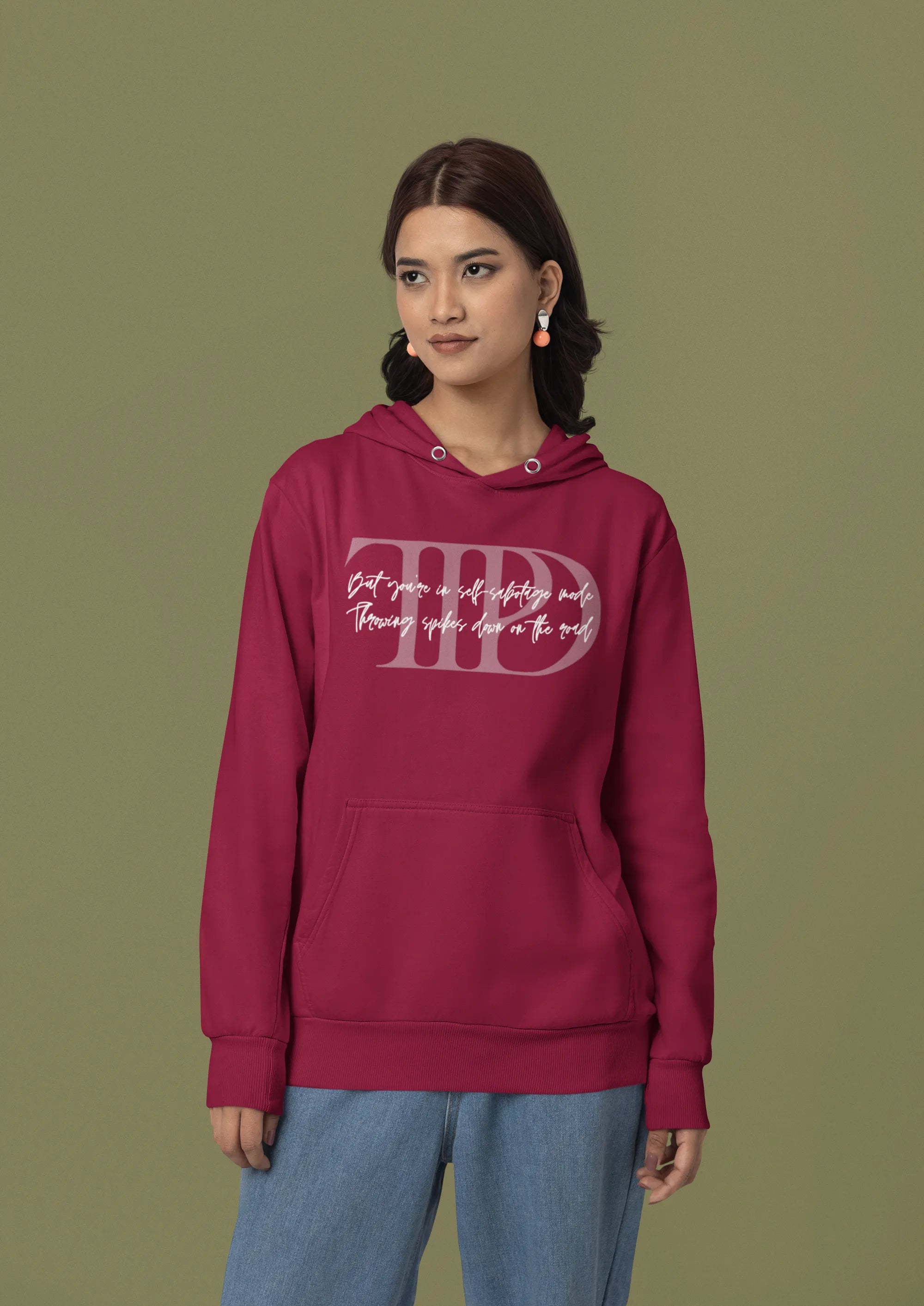 First front view of a female model wearing a maroon oversized, cozy hoodie featuring "Lamenting" lyrics from Taylor Swift's TTPD era. Perfect for Swifties looking for comfortable Eras Tour merch.