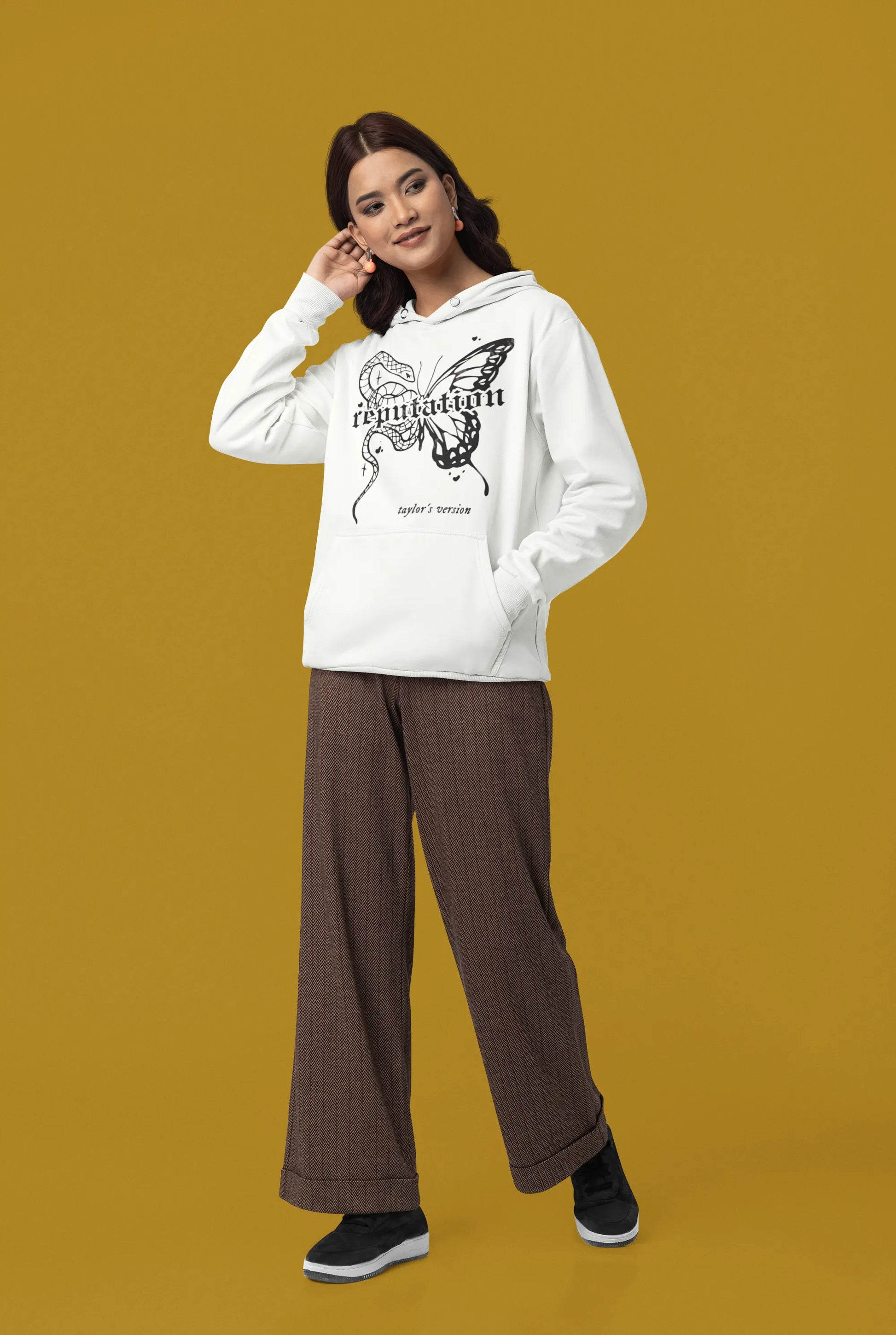 Side view of a female model wearing a off-white Reputation-inspired hoodie, perfect for Taylor Swift fans and Eras Tour enthusiasts.