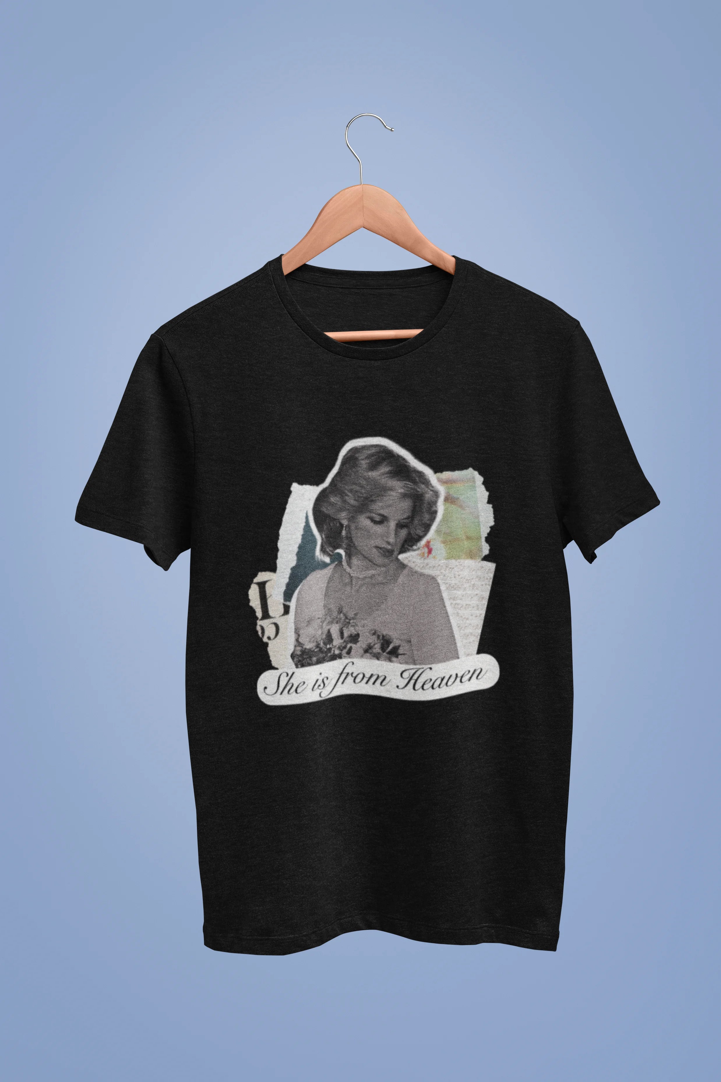 Front view of a black oversized t-shirt featuring a black and white photo of Princess Diana with the text "She is from Heaven." Ideal for fans of Princess Diana and those who want to celebrate a royal icon.