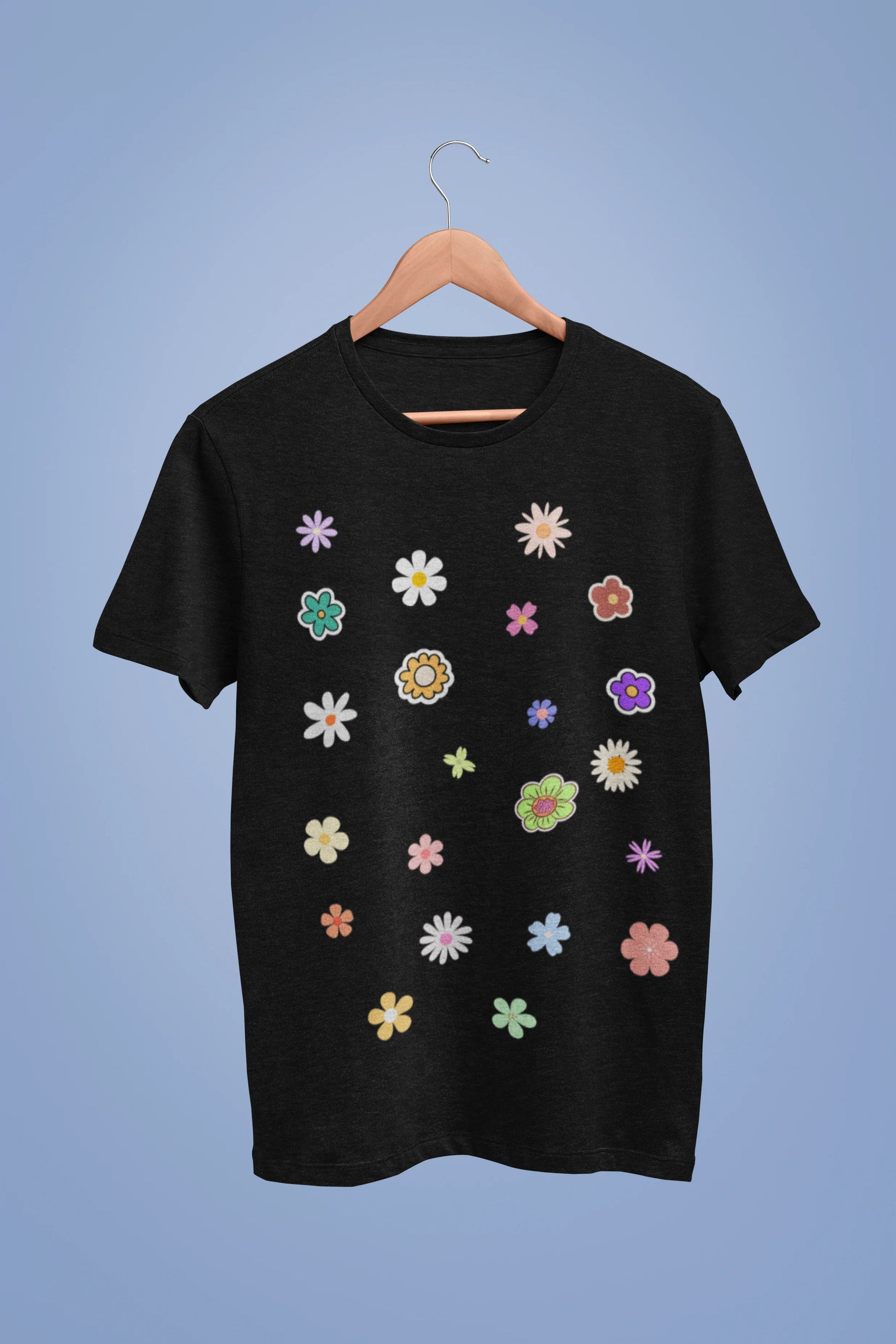 A black oversized t-shirt featuring a vibrant floral design with roses, tulips, sunflowers, and orchids. Ideal for those who love floral patterns and spring fashion.