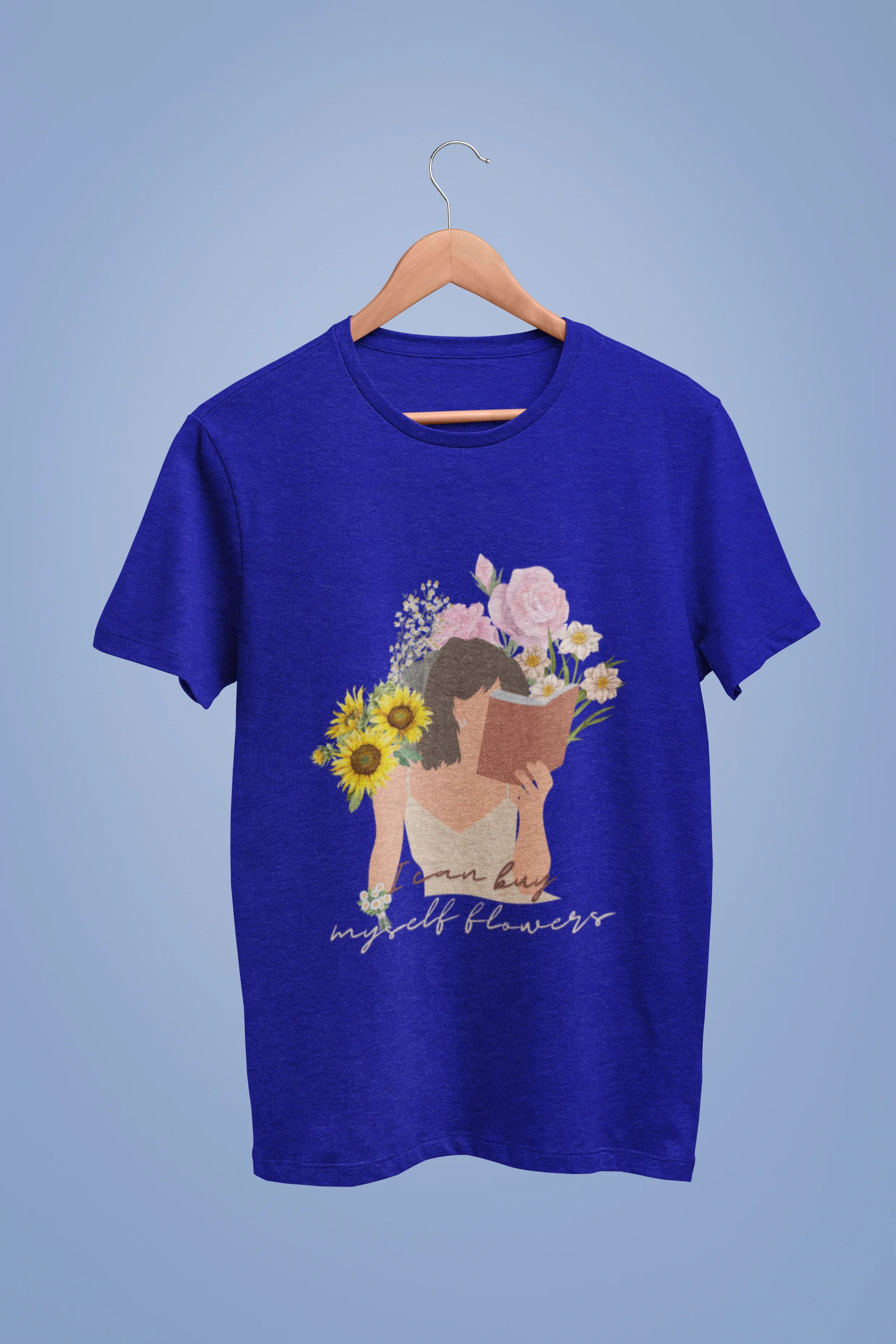 A royal blue oversized t-shirt with a positive message "Buy Myself Flowers" and a graphic of a smiling woman surrounded by tulips and sunflowers. Ideal for those who love inspirational clothing and floral designs.