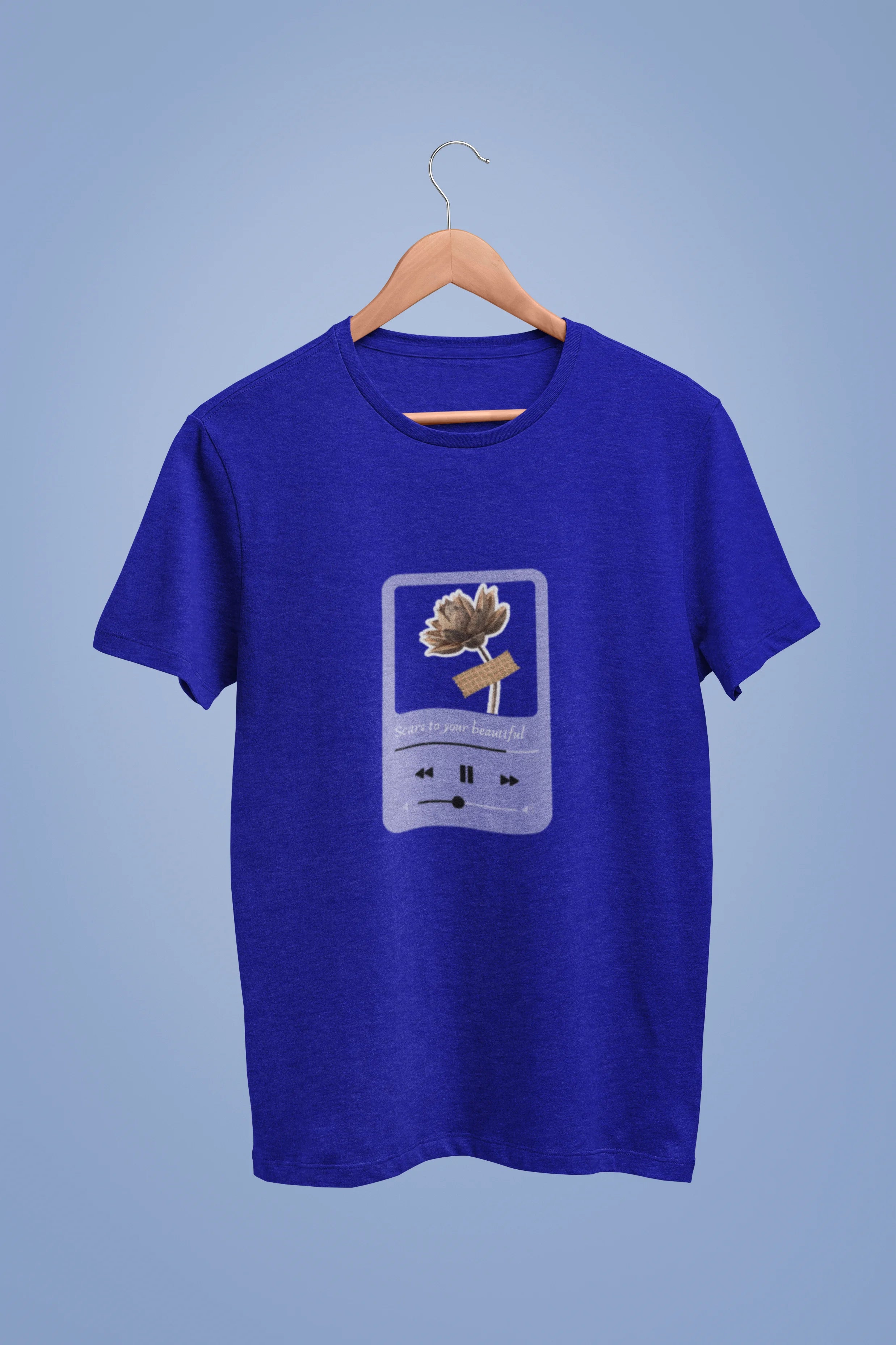 View a royal blue oversized t-shirt featuring a design inspired by Alessia Cara's song "Scars to Your Beautiful." The design includes flowers and a message of self-love. Ideal for fans of Alessia Cara and those who appreciate messages of empowerment.