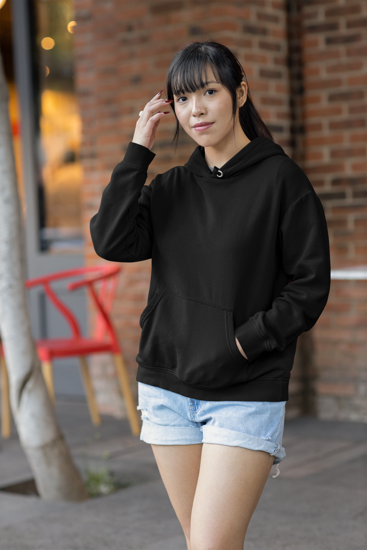 Front view of a female model wearing a black premium quality, pure cotton hoodie.