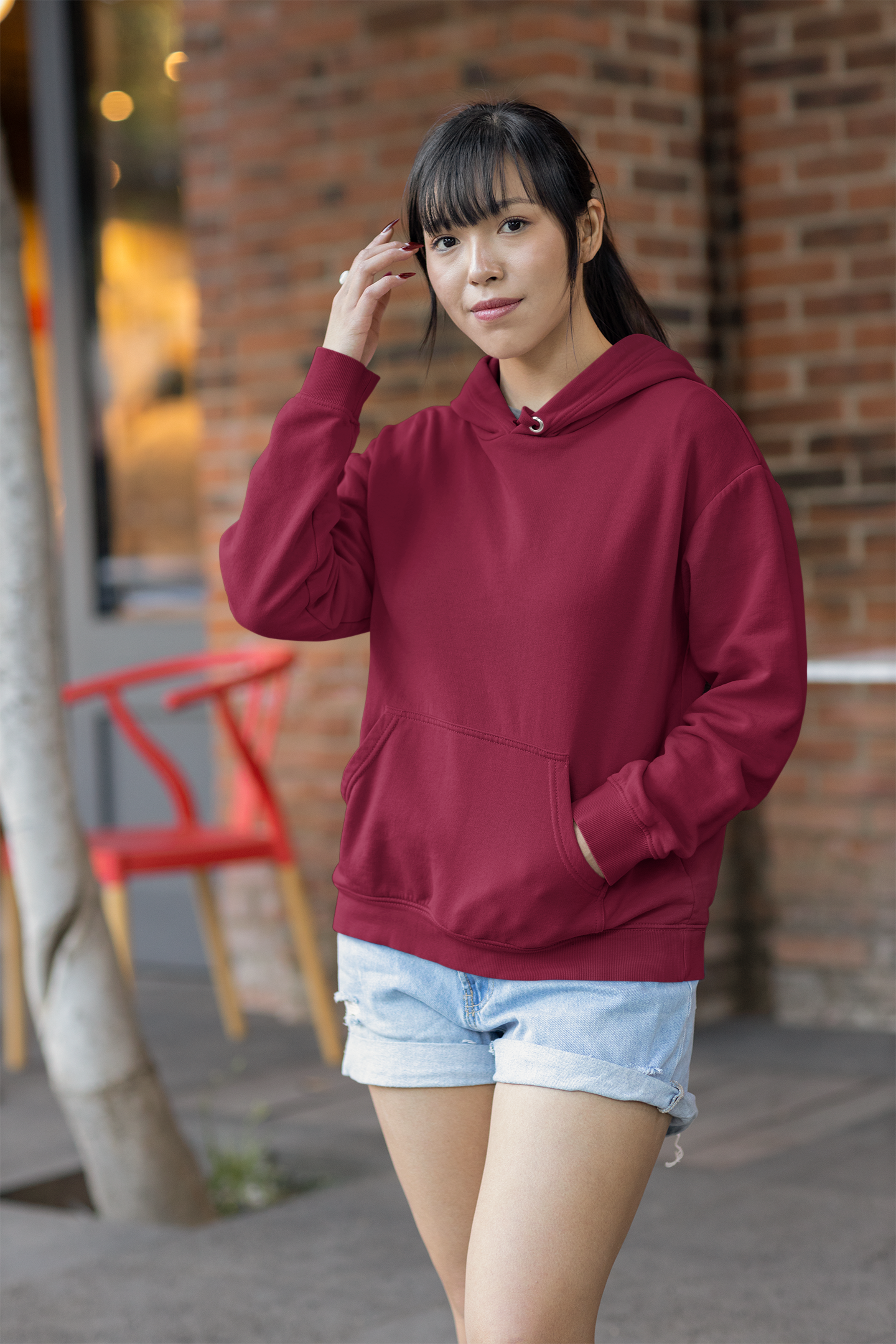 Front view of a female model wearing a maroon premium quality, pure cotton hoodie.