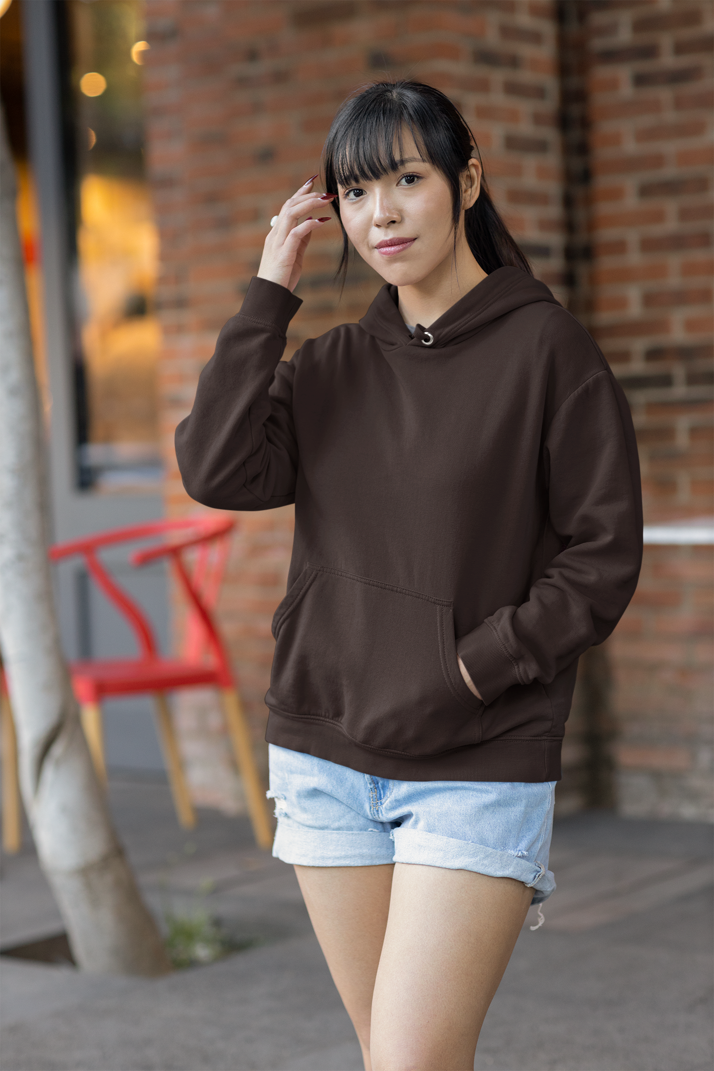 Front view of a female model wearing a chocolate brown premium quality, pure cotton hoodie.