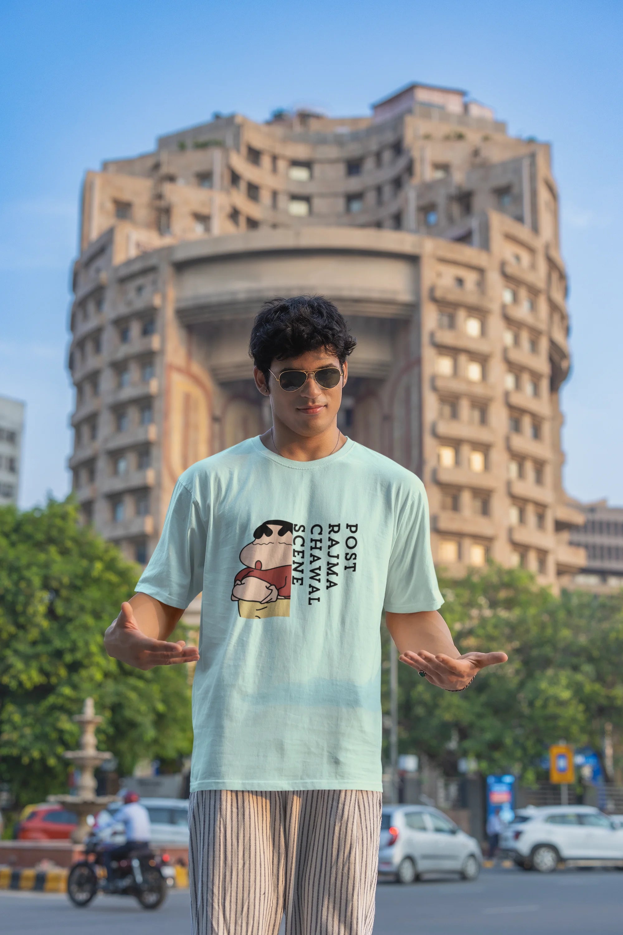 Second front image of male model wearing an oversized mint green tee with a humorous design of Shinchan enjoying a food coma. A must-have for Shinchan fans and food lovers.