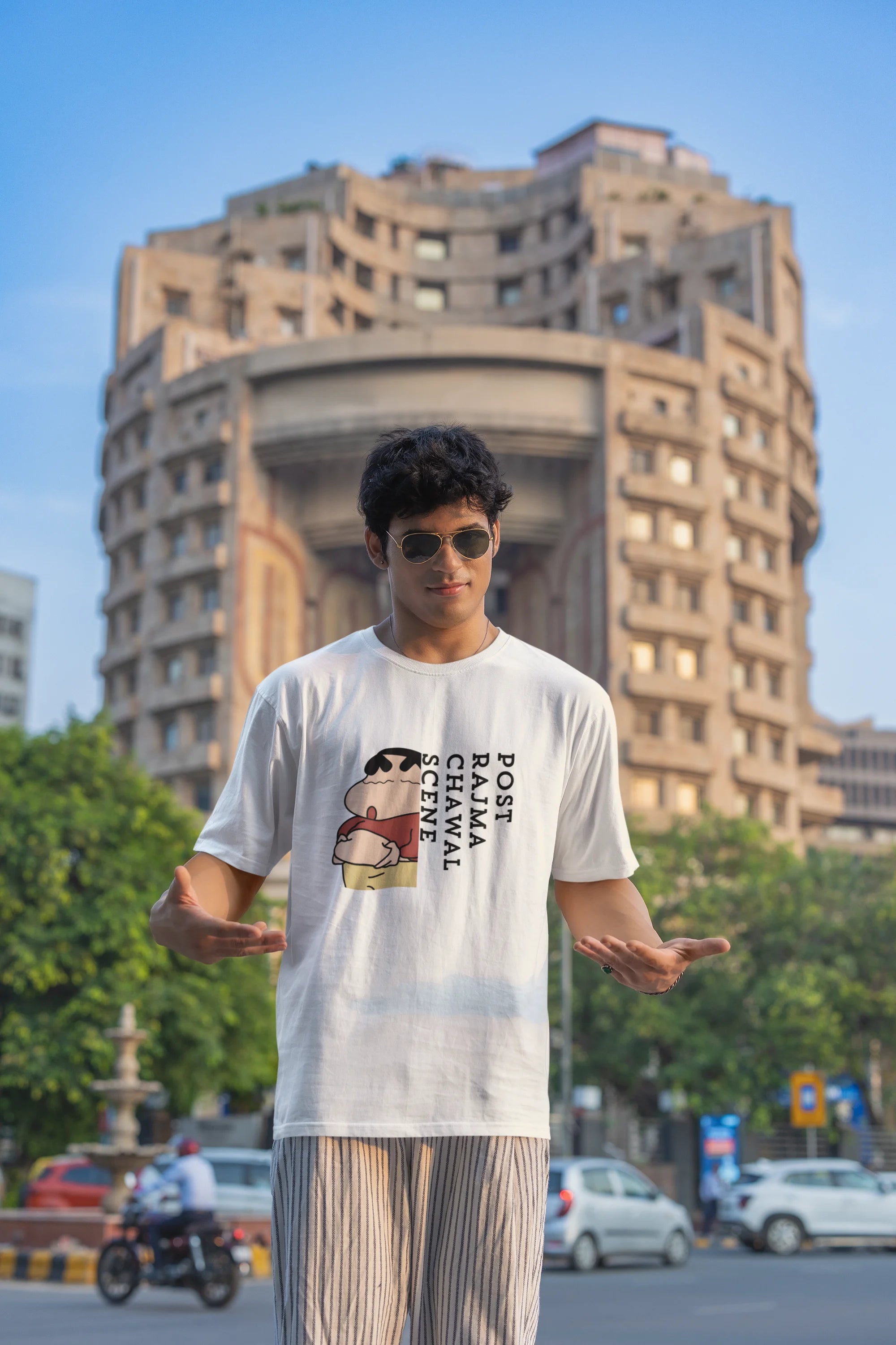 Second front image of male model wearing an oversized off-white tee with a humorous design of Shinchan enjoying a food coma. A must-have for Shinchan fans and food lovers.