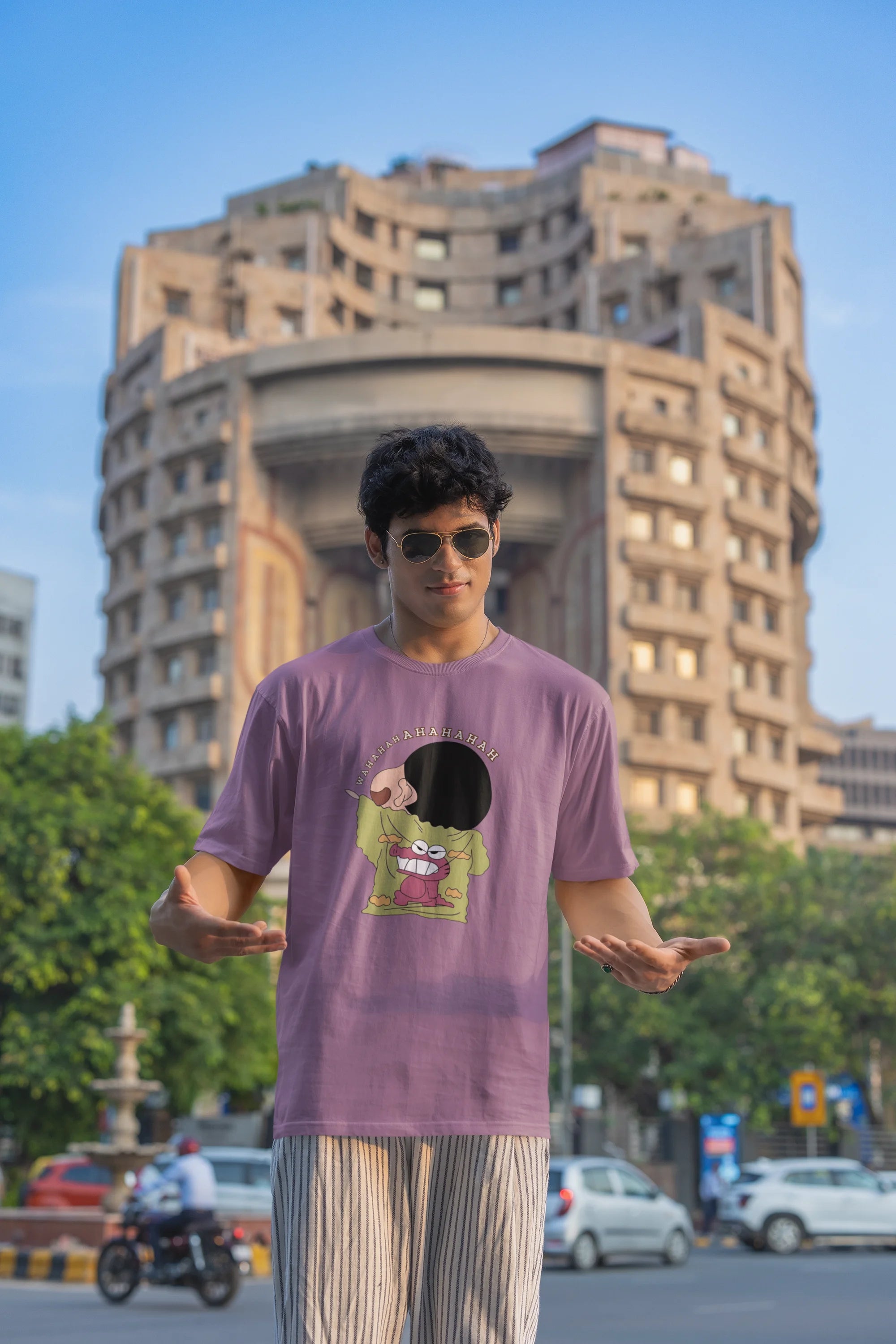 First front view of male model wearing a dirty purple oversized t-shirt with a design of Shinchan laughing hysterically. Perfect for Shinchan fans who love the character's humor.