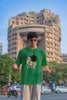 First front view of male model wearing a forest green oversized t-shirt with a design of Shinchan laughing hysterically. Perfect for Shinchan fans who love the character's humor.