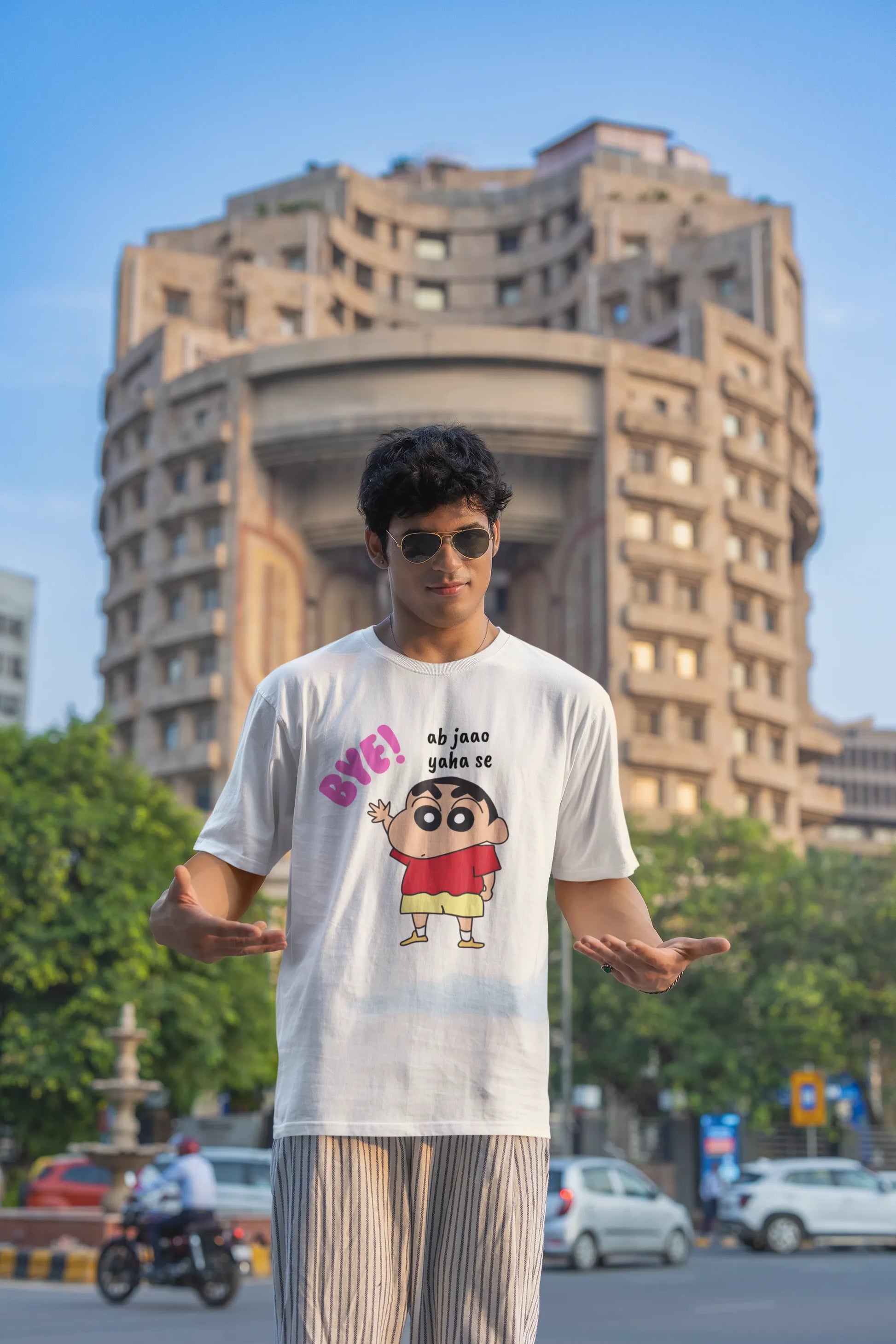 Third front view of an male model wearing an off-white oversized tee featuring Shinchan saying "Ab Jhao" in Hindi. A perfect blend of humor and nostalgia for Shinchan fans.