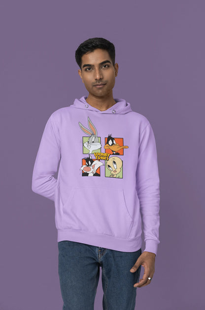 Fourth image of a male model wearing a lavender hoodie with a large Looney Tunes design. The illustration features portraits of several iconic Looney Tunes characters.
