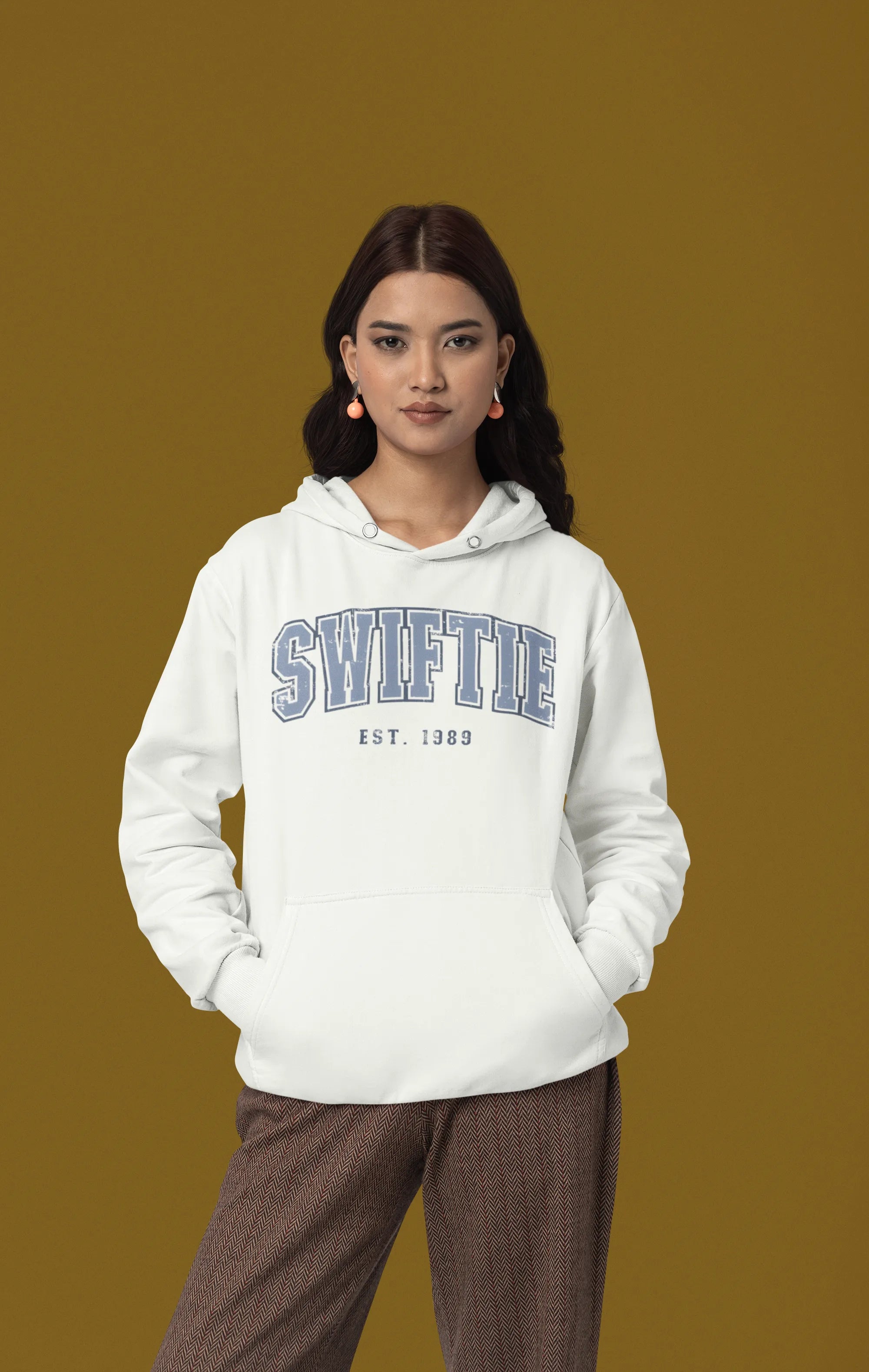 First front view of a female Model wearing an off-white Swiftie hoodie, perfect for Taylor Swift fans and Eras Tour enthusiasts.