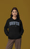 First front view of a female Model wearing an black Swiftie hoodie, perfect for Taylor Swift fans and Eras Tour enthusiasts.