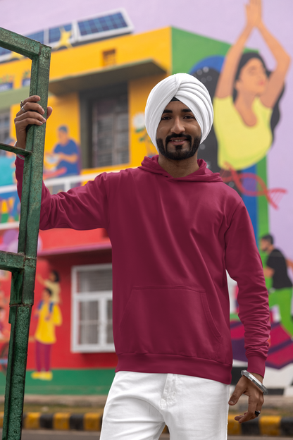 Front view of a male model wearing a maroon hoodie with a portrait of Diljit Dosanjh and lyrics from the song "Ikk Kudi."