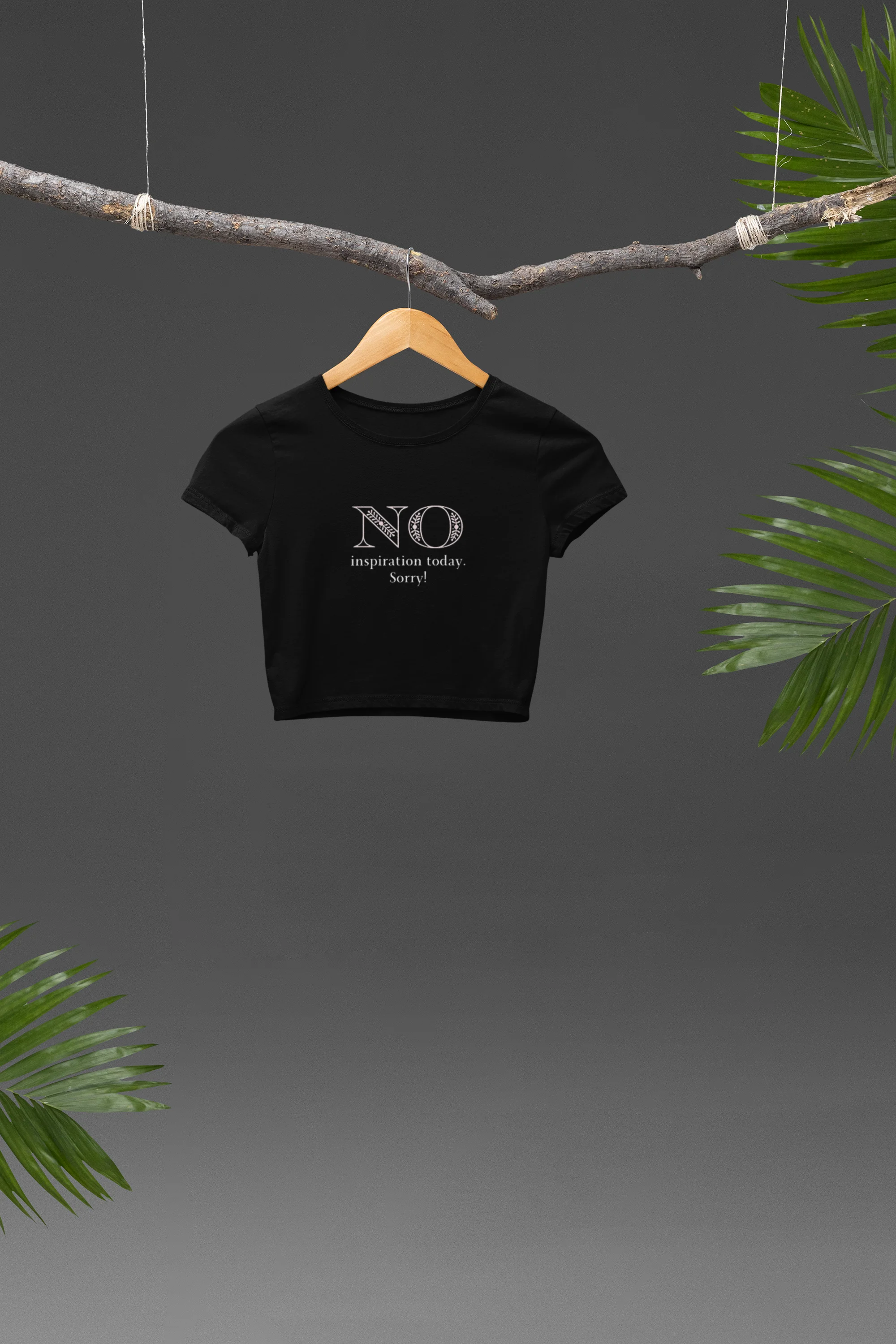 Front view of a black crop top with "No Inspiration Today" text, exuding a cool and relatable vibe.