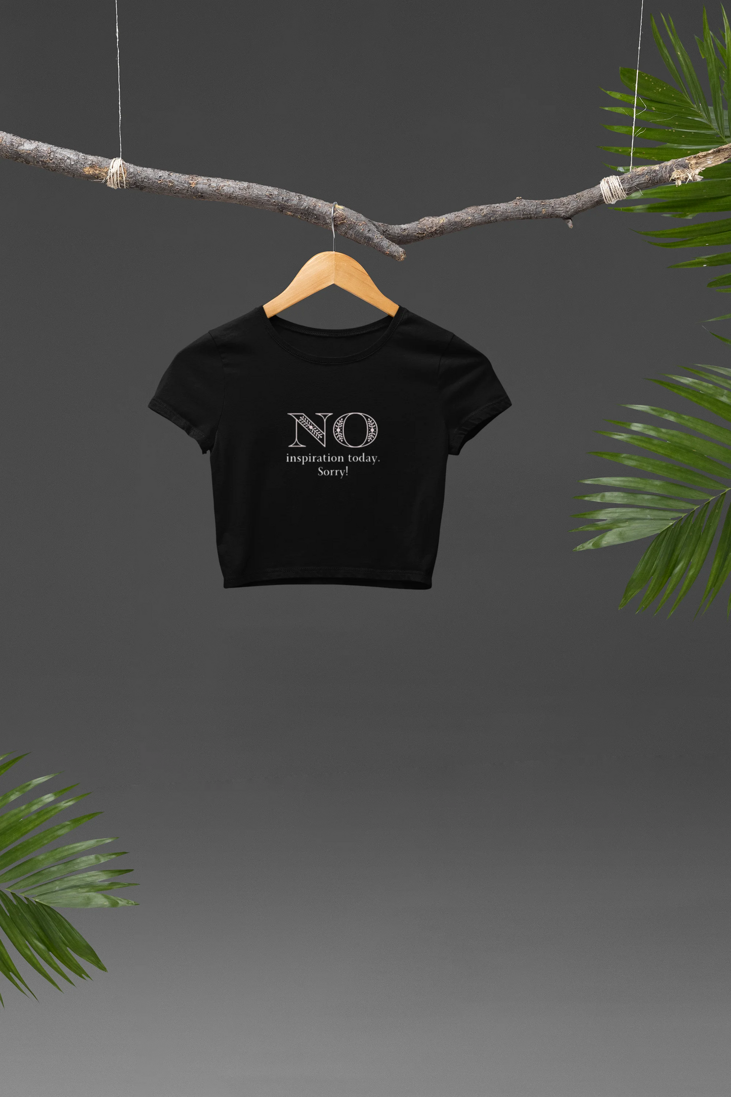 Front view of a black crop top with "No Inspiration Today" text, exuding a cool and relatable vibe.