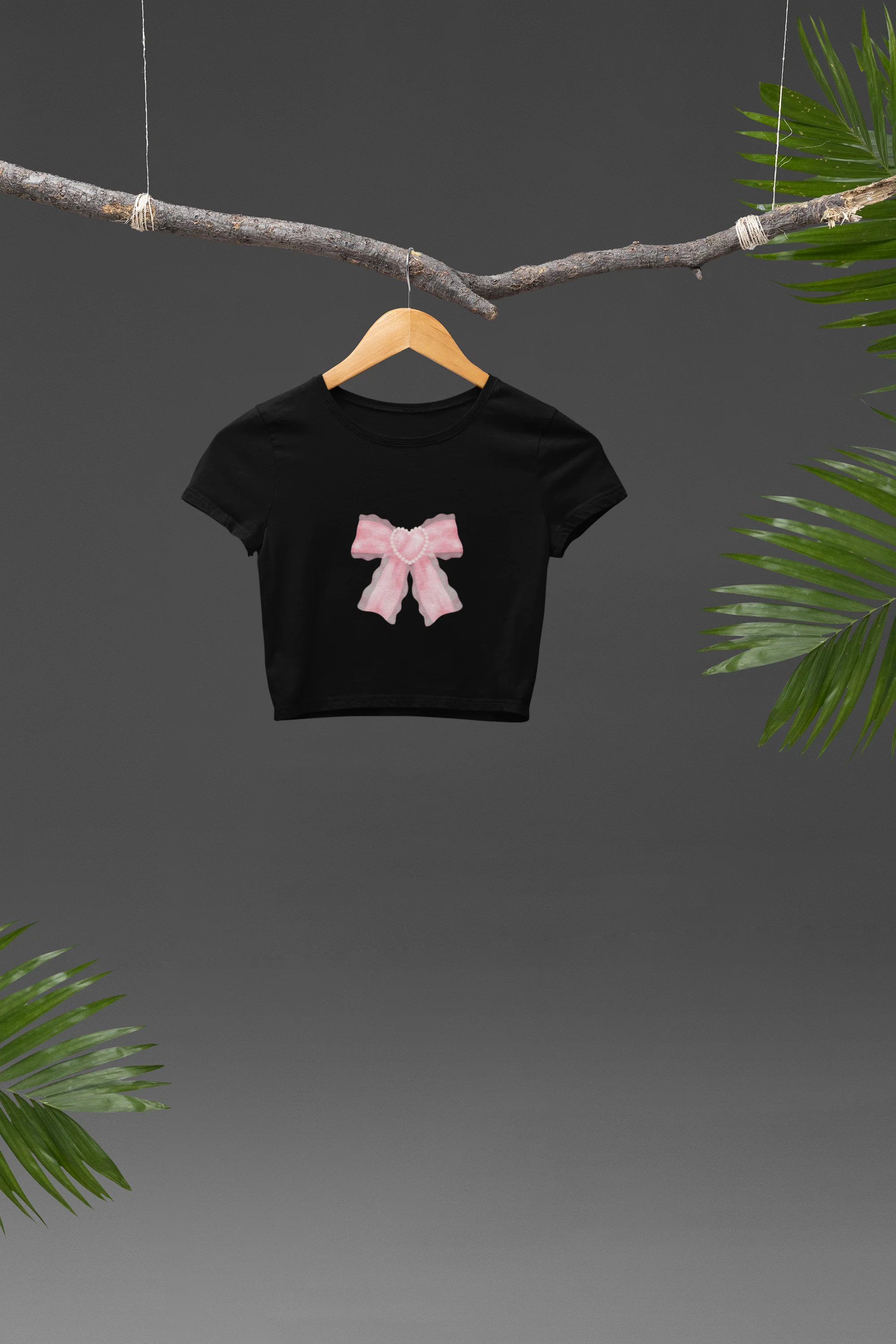 Front view of a stylish black crop top with a bow design, embodying the Pookie trend.