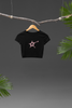 Front view of a black crop top with a shooting star (Starblink) design, radiating confidence and style.