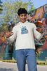 Fourth front view of a male model wearing a white hoodie with a large Stitch design. The illustration shows Stitch smiling and waving.