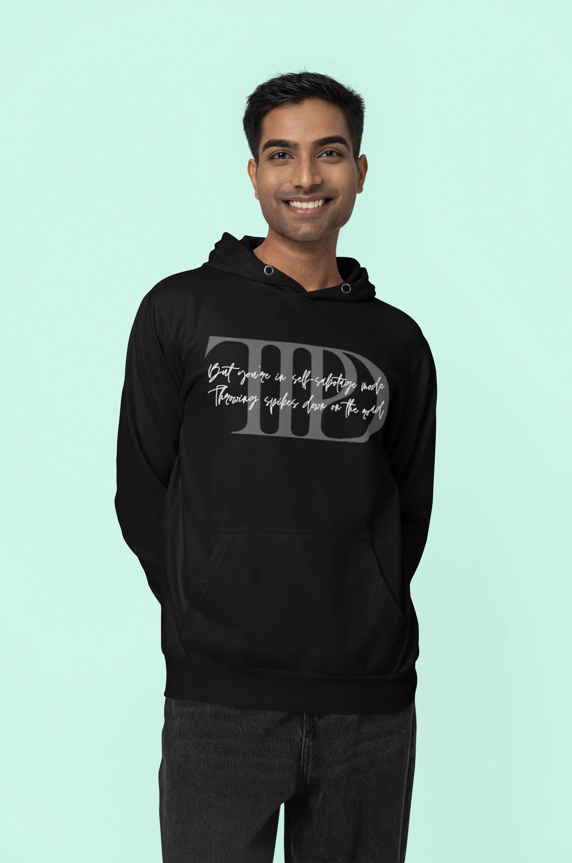 Third front view of a male model wearing a black oversized, cozy hoodie featuring "Lamenting" lyrics from Taylor Swift's TTPD era. Perfect for Swifties looking for comfortable Eras Tour merch.