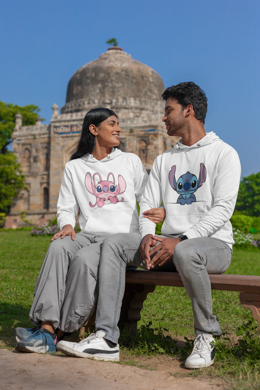 2nd front view of a couple wearing matching white hoodies, one with a Stitch design and the other with an Angel design.