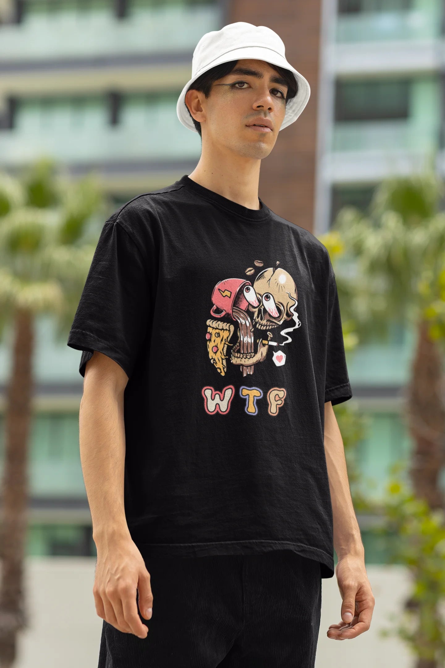 Right side view of a male model wearing an black oversized t-shirt featuring a skull enjoying coffee, pizza, and smoking, offering a unique and edgy aesthetic.