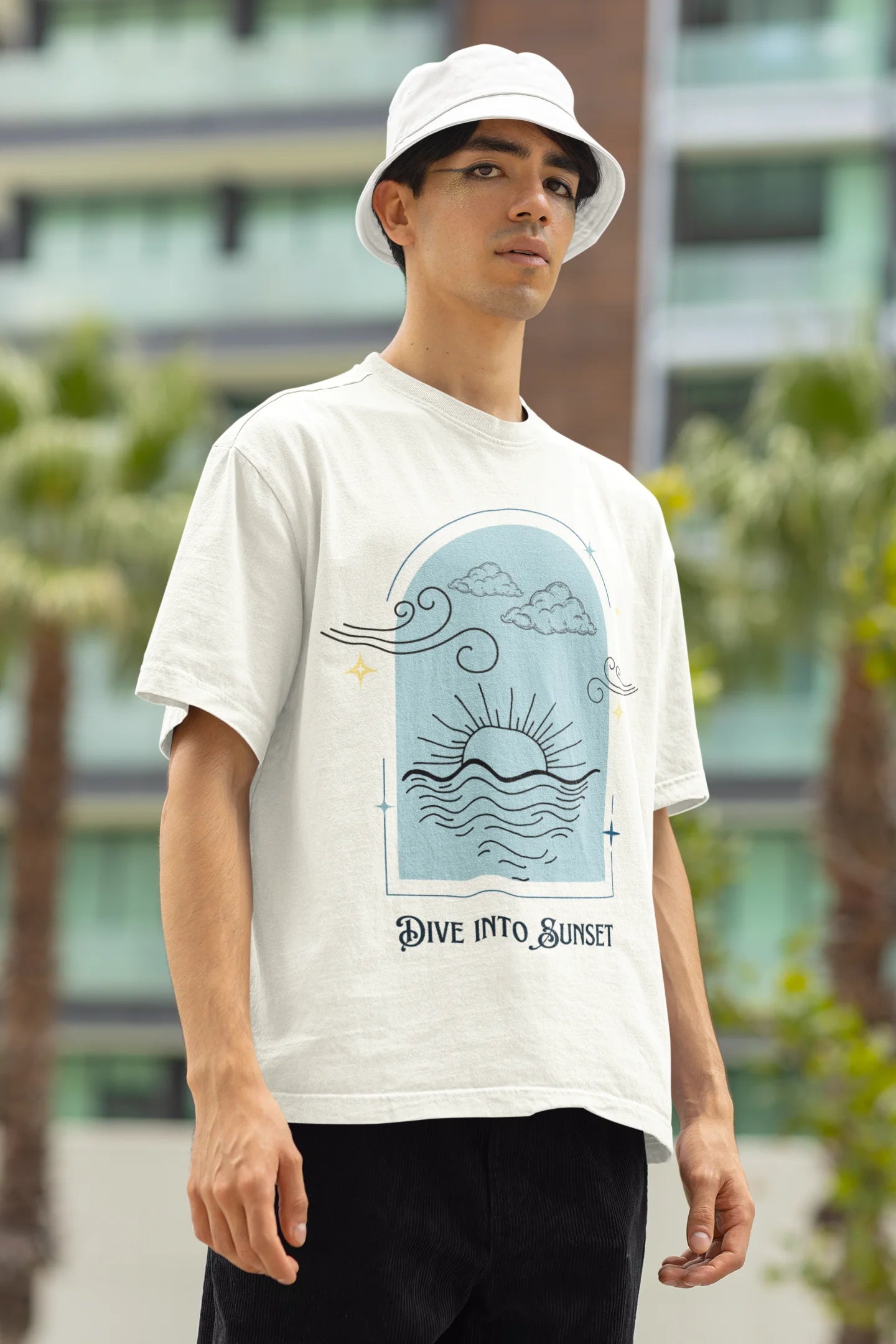 Right side view of a male model wearing a off-white oversized t-shirt with a beautiful outline of the sun setting into the sea, offering a serene and coastal aesthetic.