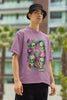 Right side view of a male model wearing a dirty purple oversized t-shirt with a psychedelic design featuring green aliens and spaceships, perfect for a hippie, trance, or groovy style.