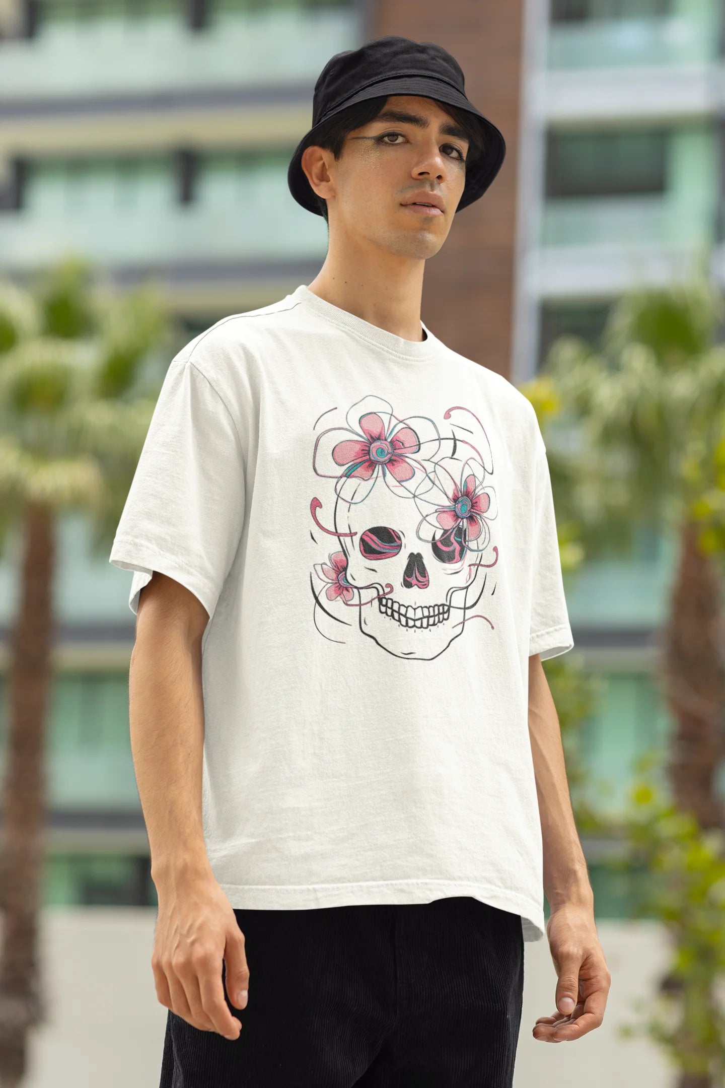 Right side view of male model wearing an off-white oversized t-shirt with a psychedelic skull flower design, perfect for a hippie, trance, or groovy style.