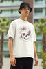 Right side view of male model wearing an off-white oversized t-shirt with a psychedelic skull flower design, perfect for a hippie, trance, or groovy style.