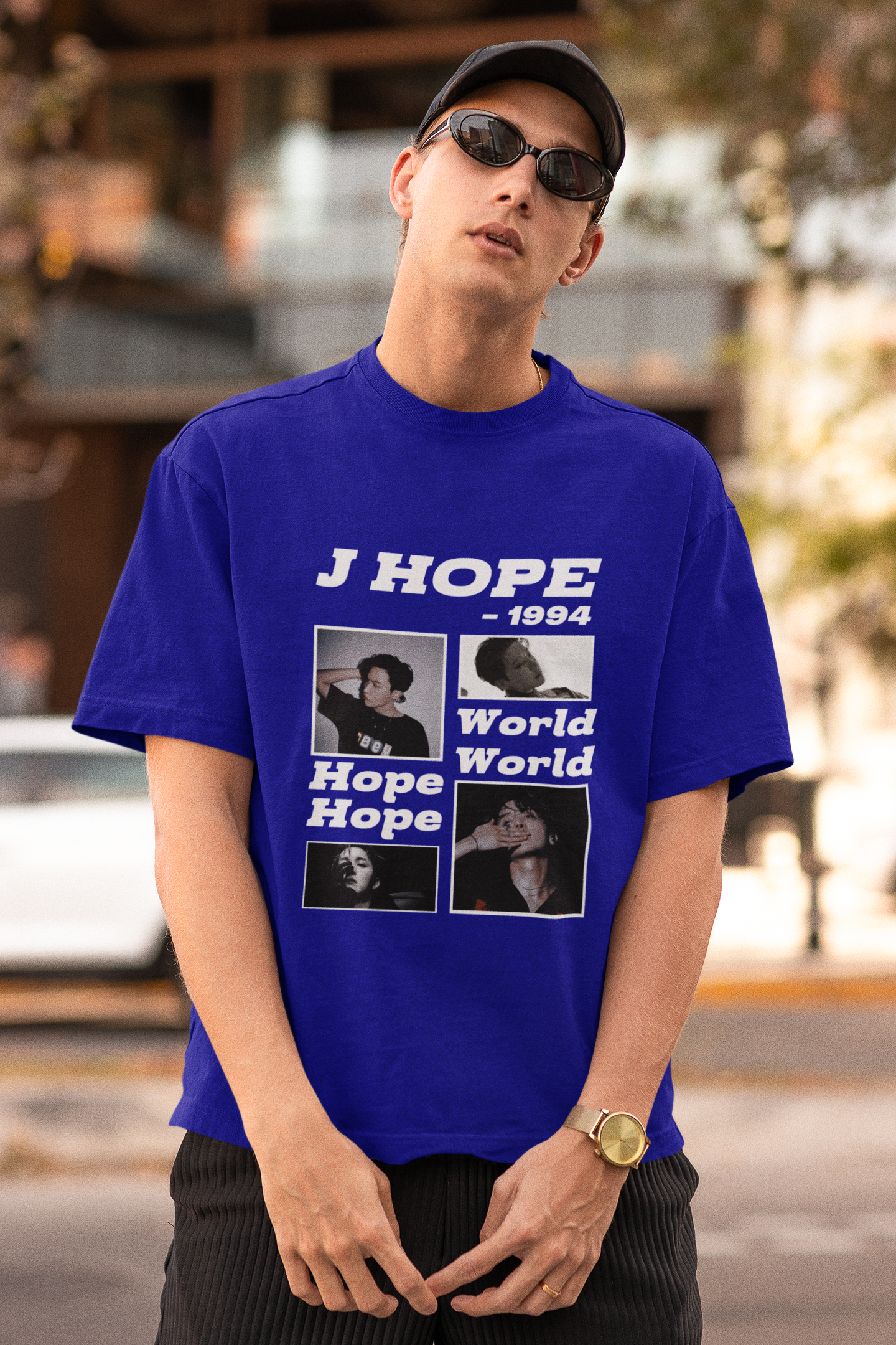 Front view of a male model wearing a royal blue oversized t-shirt featuring a vibrant design inspired by BTS member J-Hope (Hoseok). Ideal for BTS fans (ARMY) and K-Pop enthusiasts who love dance and rap-focused music.