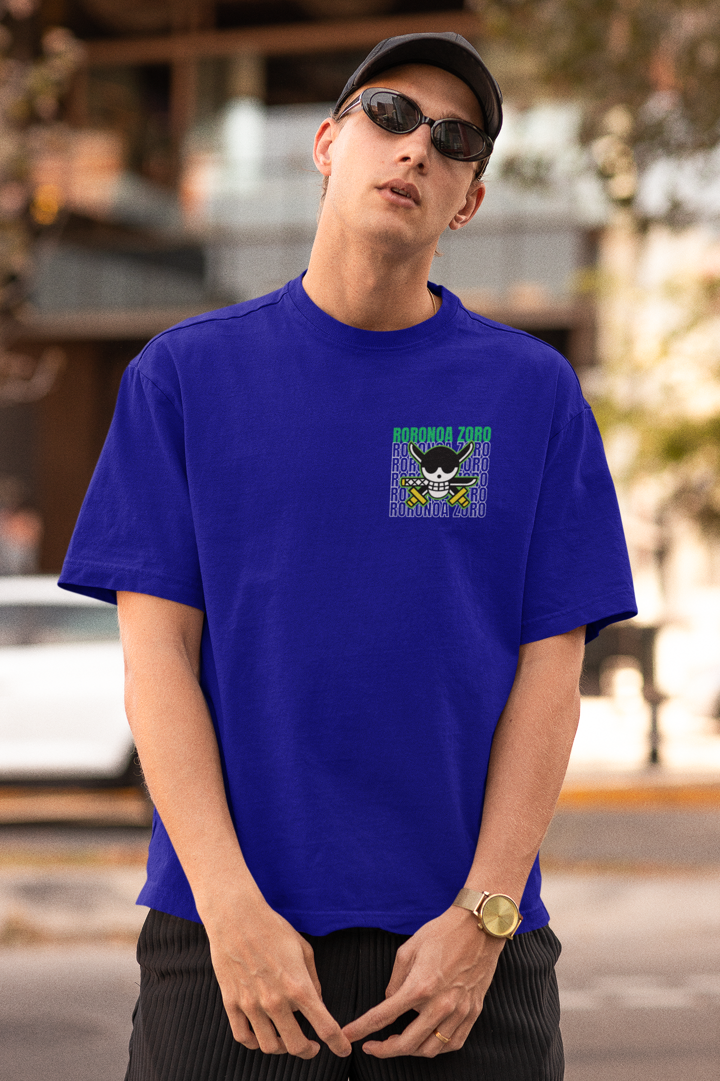 First front view of a male model wearing a royal blue oversized t-shirt featuring Roronoa Zoro from the One Piece anime.