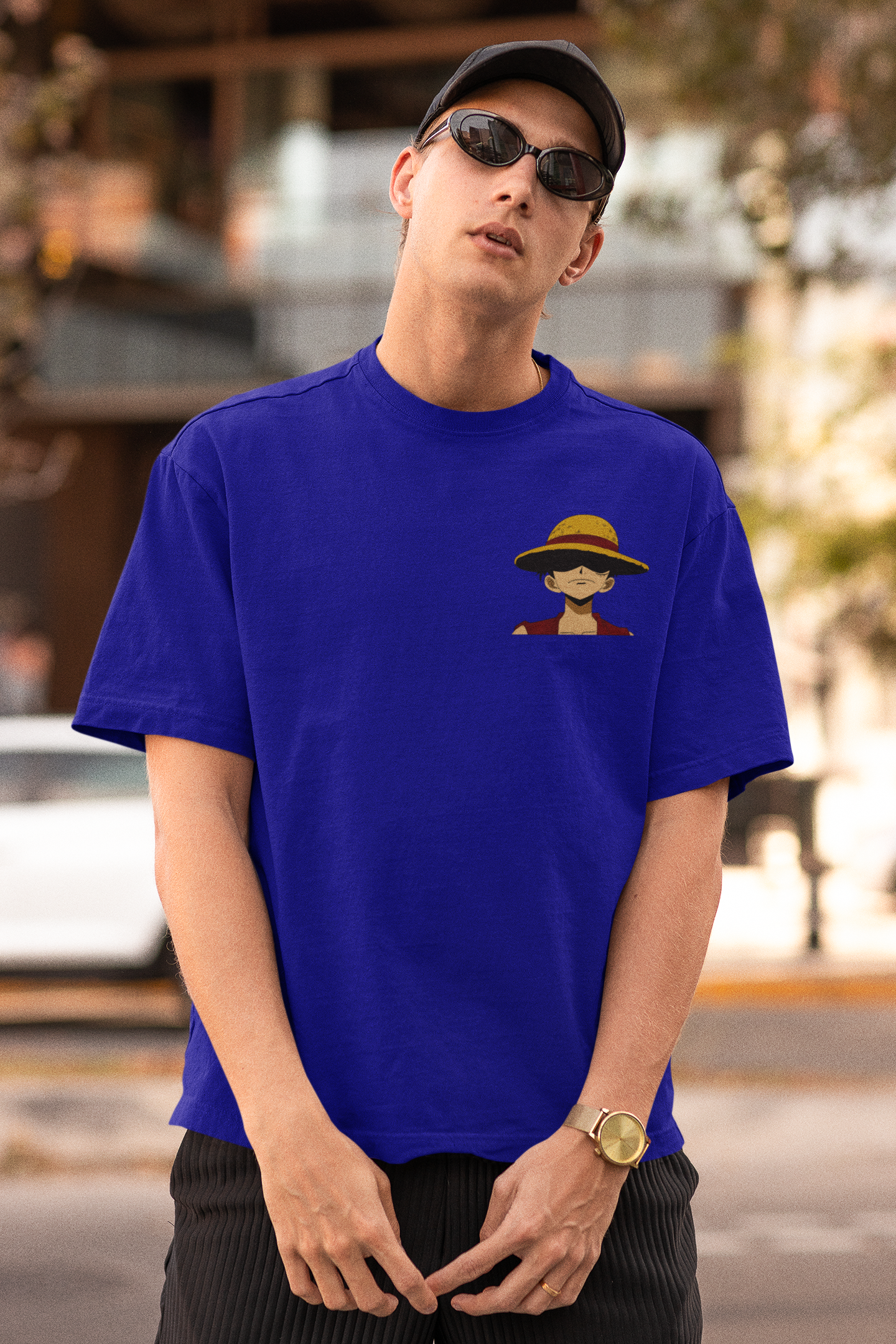 Front view of a male model wearing a royal blue oversized t-shirt featuring Monkey D. Luffy from the One Piece anime.