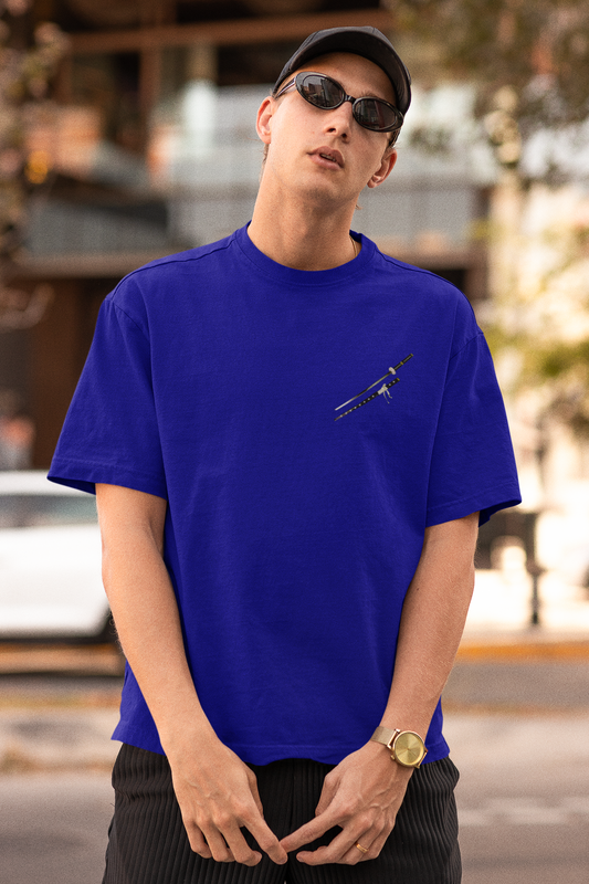 Front view of a male model wearing a royal blue oversized t-shirt featuring Trafalgar Law from the One Piece anime.