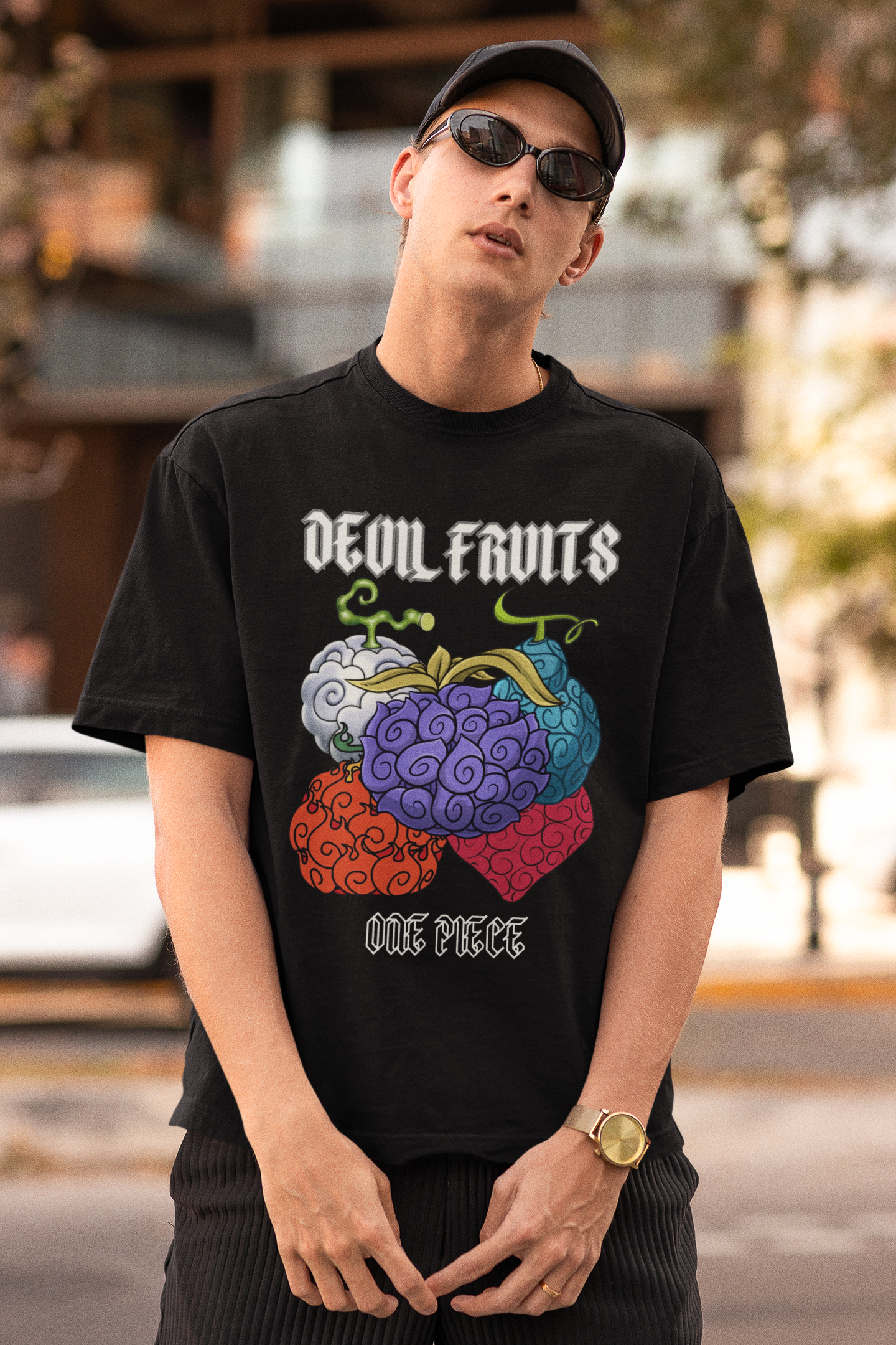 First front view of a male model wearing a black oversized t-shirt featuring a design of a Devil Fruit from the One Piece anime.