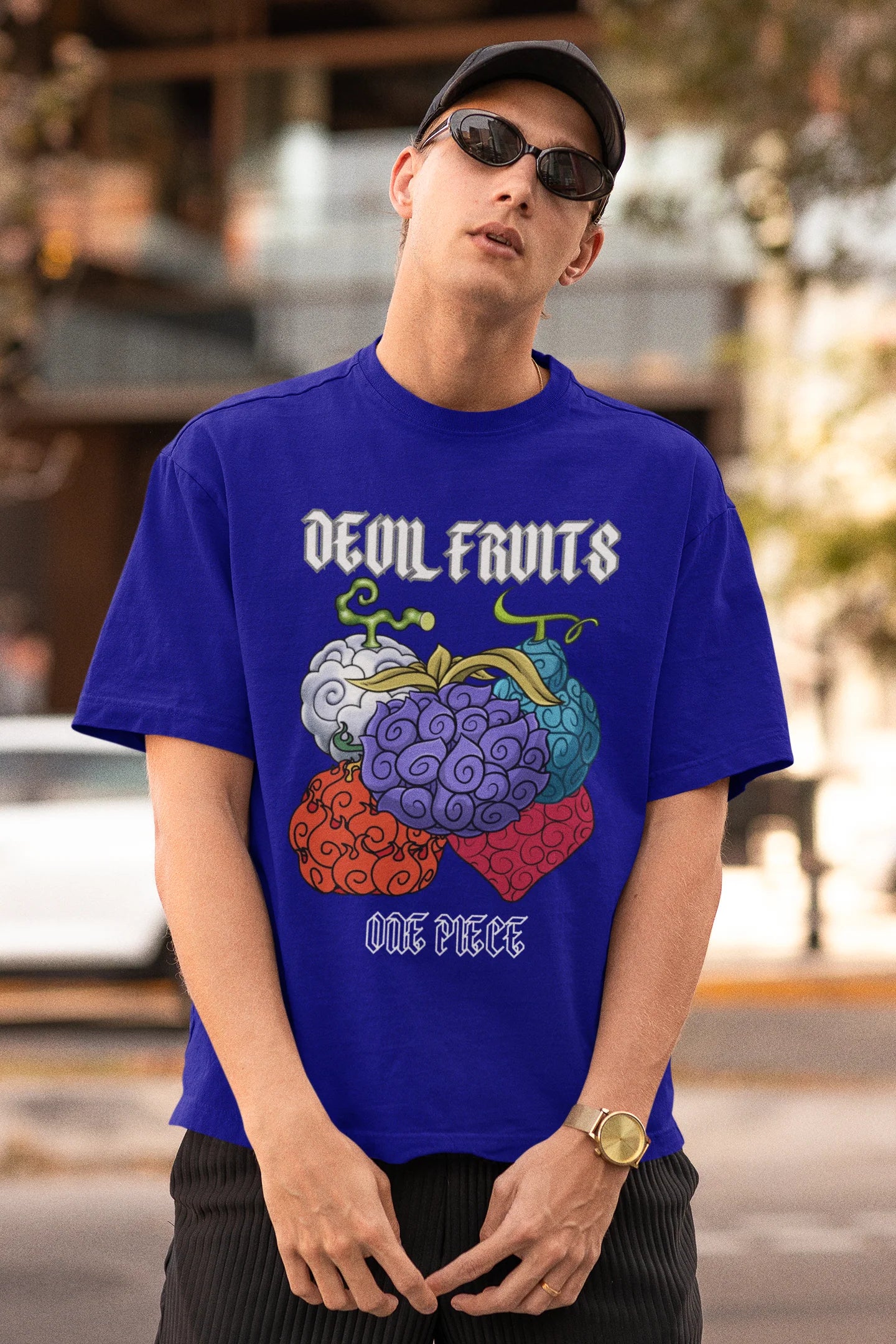 3rd front view of a male model wearing a royal blue oversized t-shirt featuring a design of a Devil Fruit from the One Piece anime.