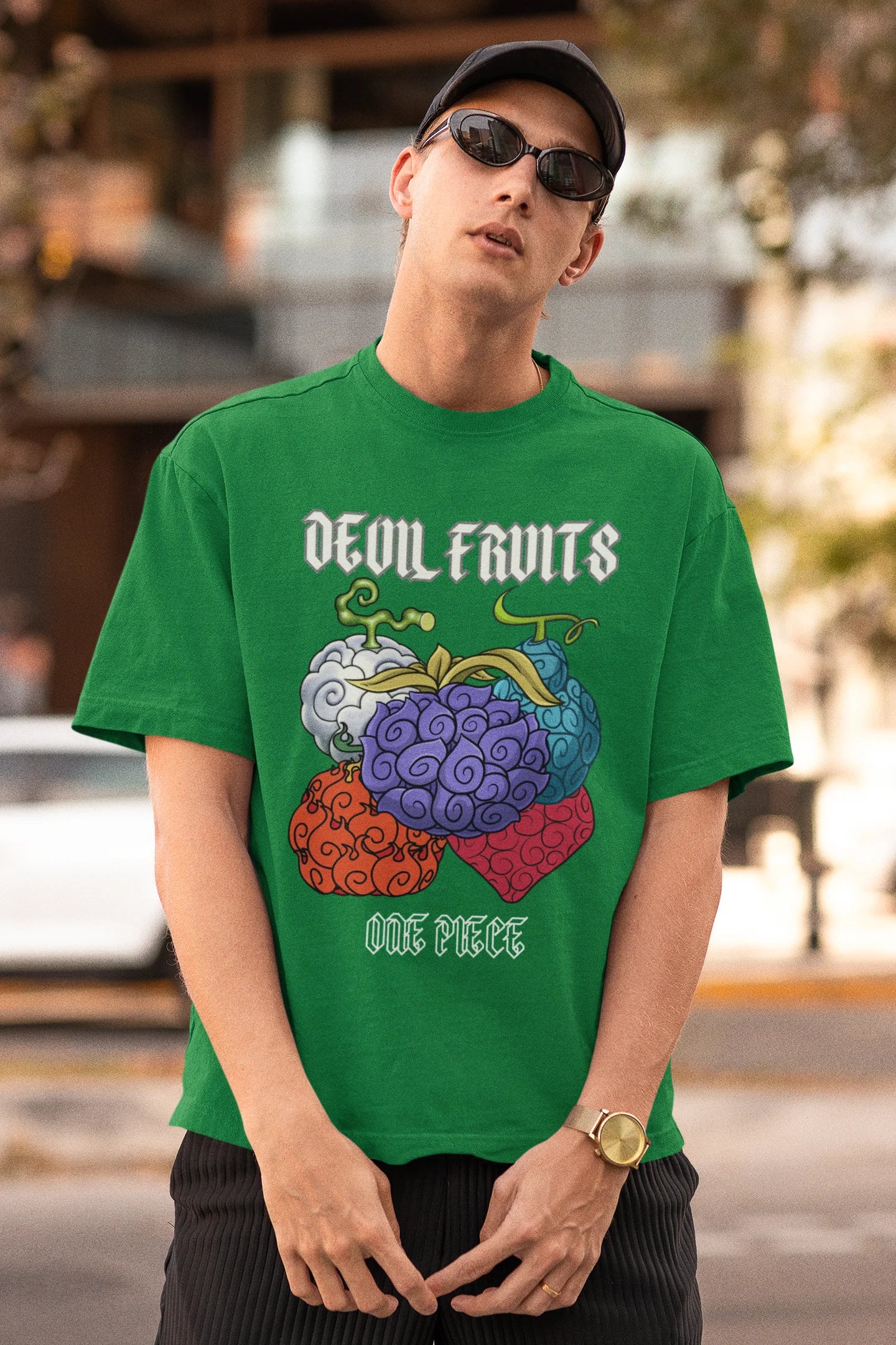 3rd front view of a male model wearing a forest green oversized t-shirt featuring a design of a Devil Fruit from the One Piece anime.
