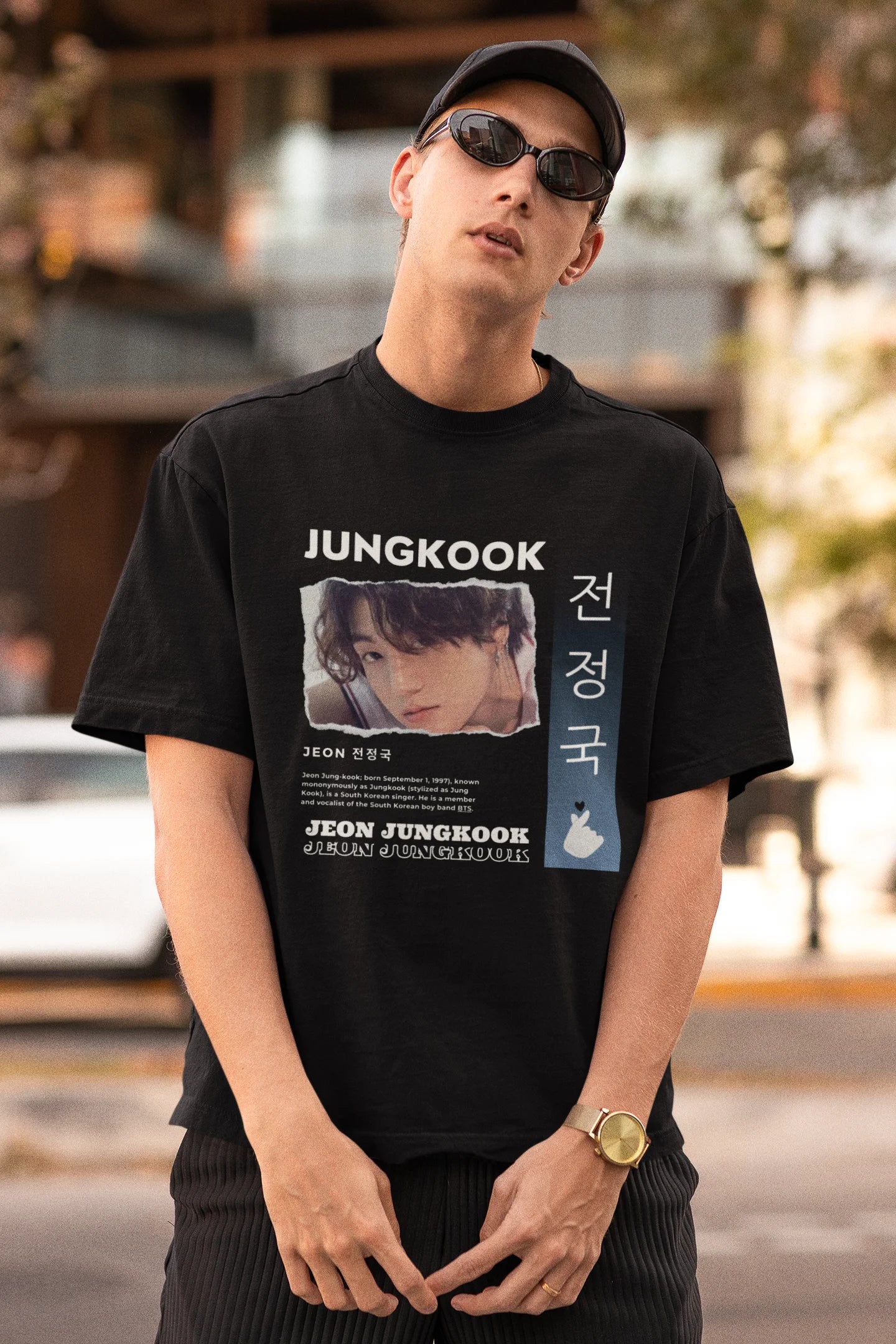 First front view of a male model wearing a black oversized t-shirt featuring a vibrant design inspired by BTS member Jungkook. Ideal for fans of BTS and K-Pop music in general.
