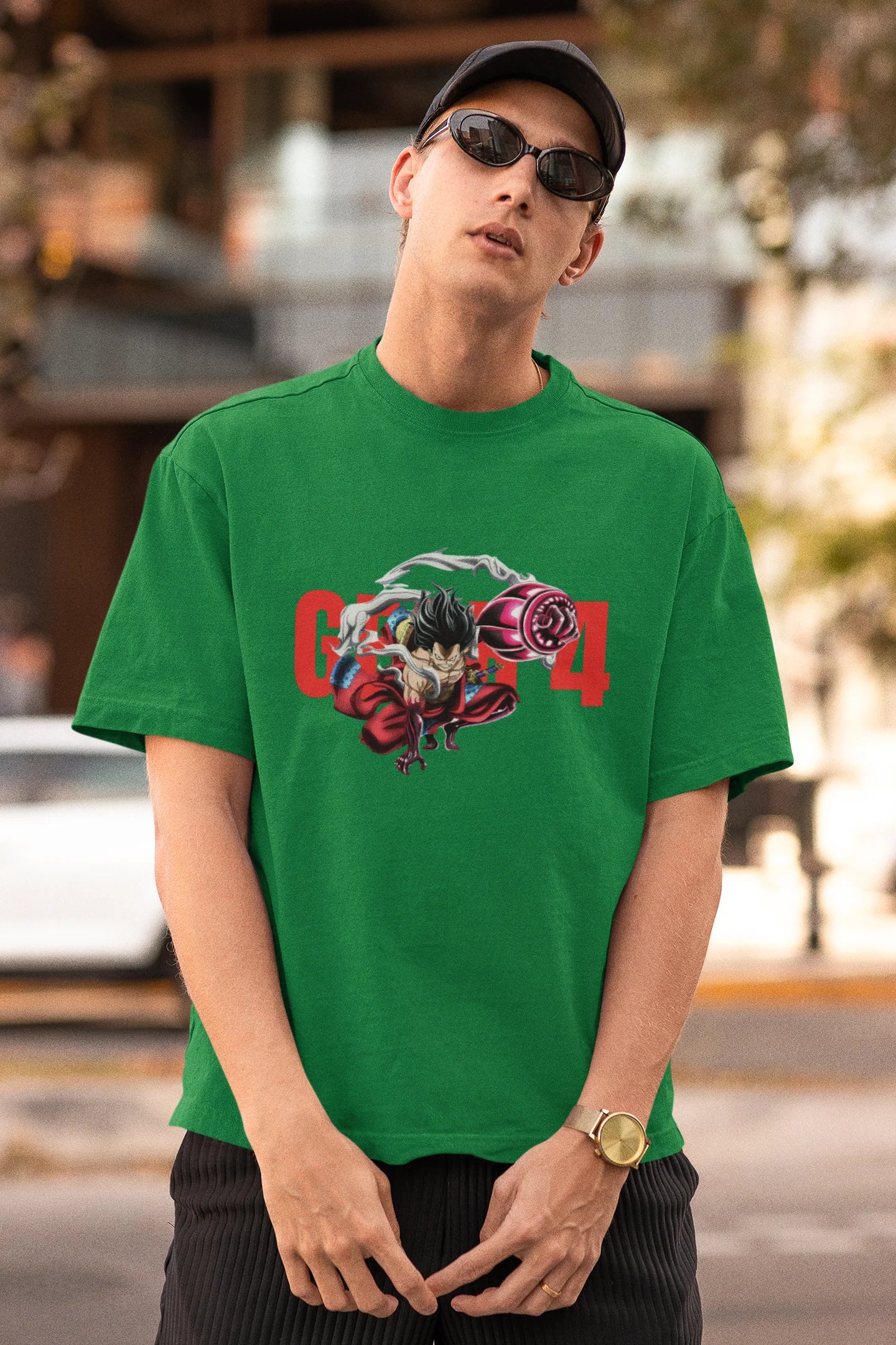 First front view of a male model wearing a forest green oversized t-shirt featuring Luffy in his Gear 4 Bounceman form from the One Piece anime.