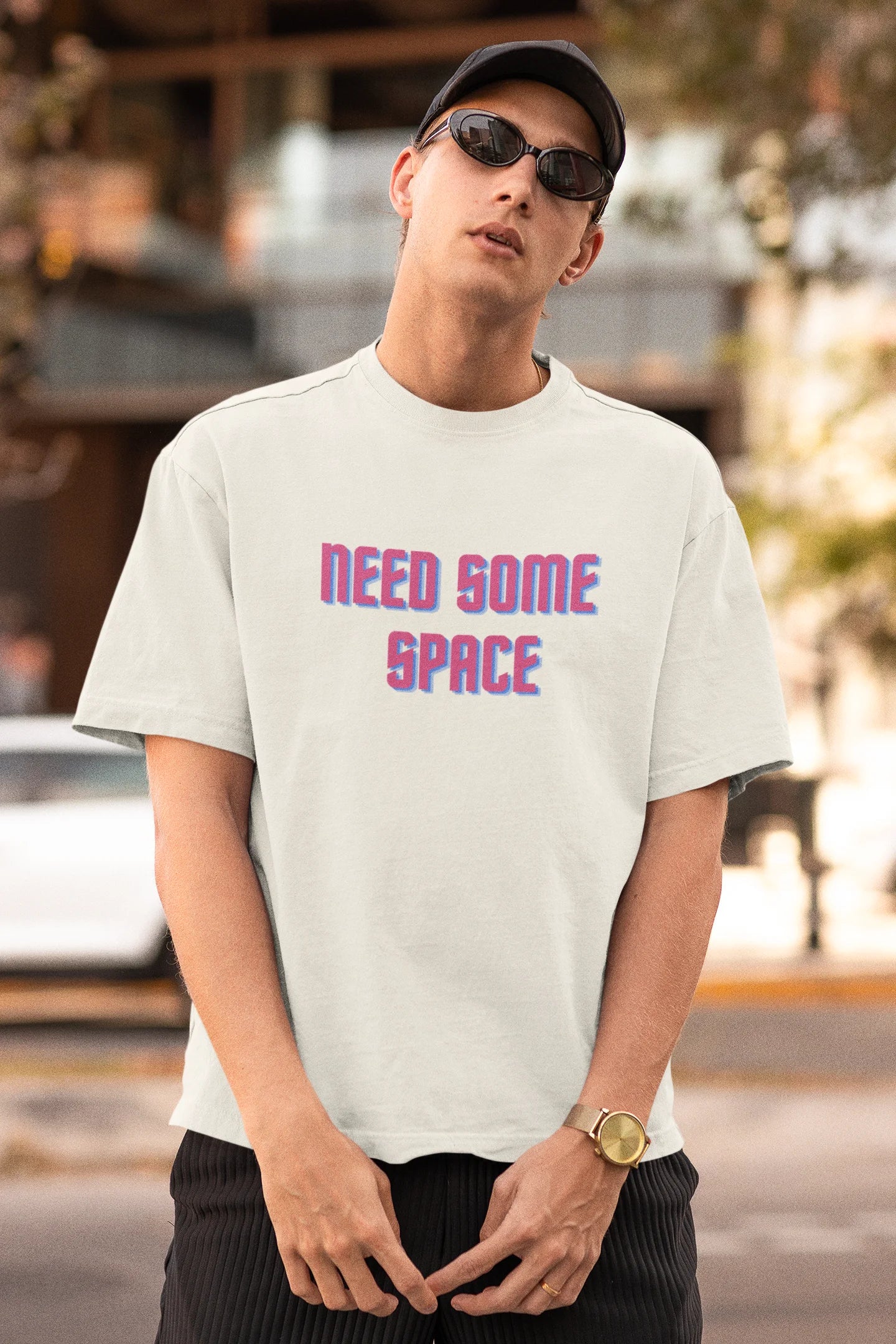 Second front view image of a male model wearing a white oversized t-shirt with a bold graphic that reads "Need Some Space" on the front. The design incorporates subtle hints of the Milky Way galaxy and the solar system on the back.