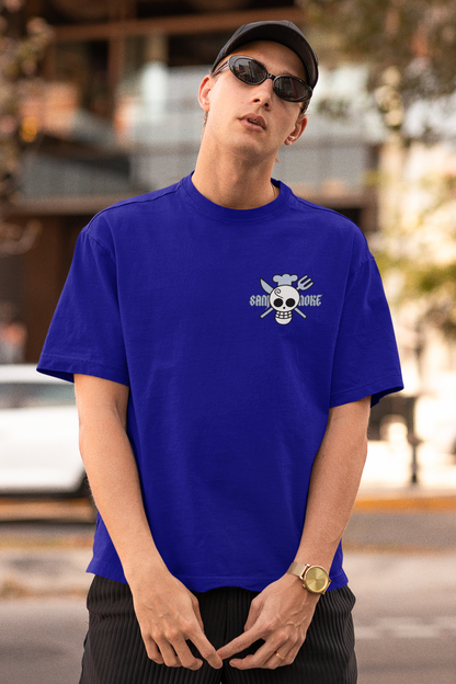 3rd front view of a male model wearing a royal blue oversized t-shirt featuring Sanji's skull and crossbones logo and the text "The Cook and Black Leg."