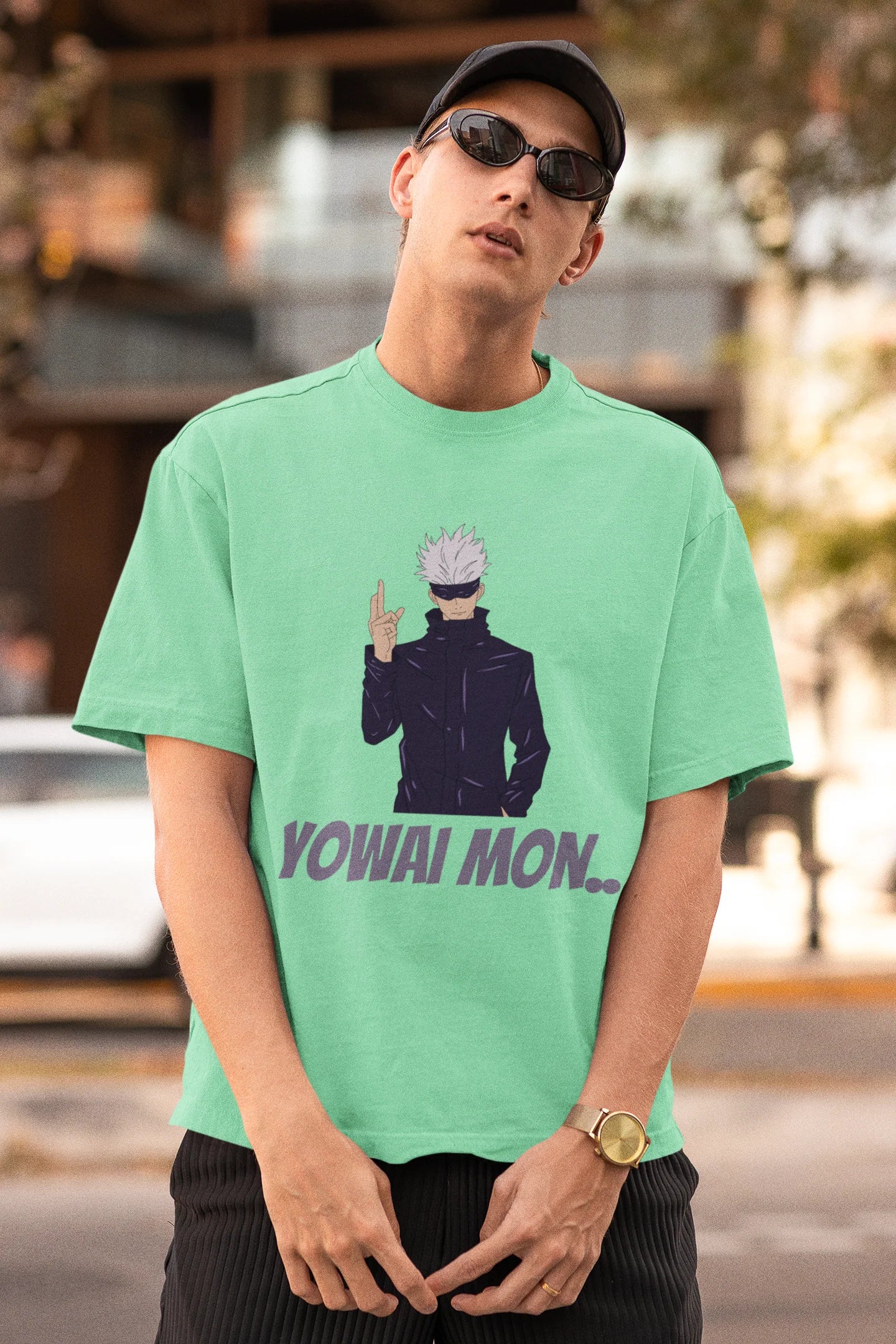 First front view of a male model wearing a mint green oversized t-shirt featuring Gojo Satoru with his fingers crossed and the text "Yowai Mon."