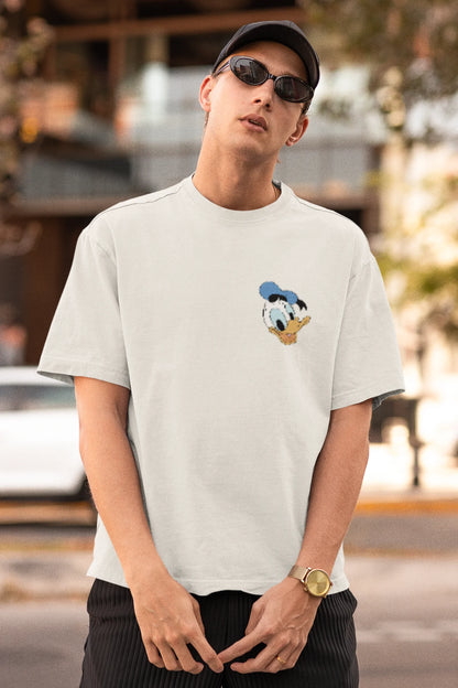 First Front view of male model wearing off white oversized Disney collection t-shirt featuring a classic Donald Duck design.