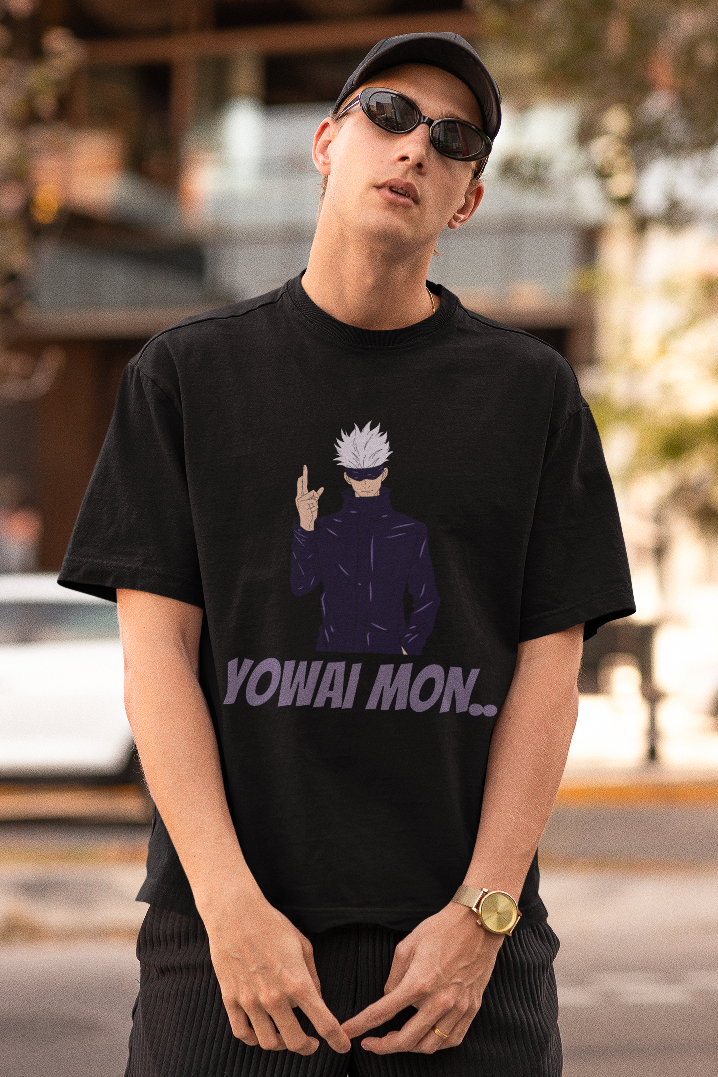 First front view of a male model wearing a black oversized t-shirt featuring Gojo Satoru with his fingers crossed and the text "Yowai Mon."