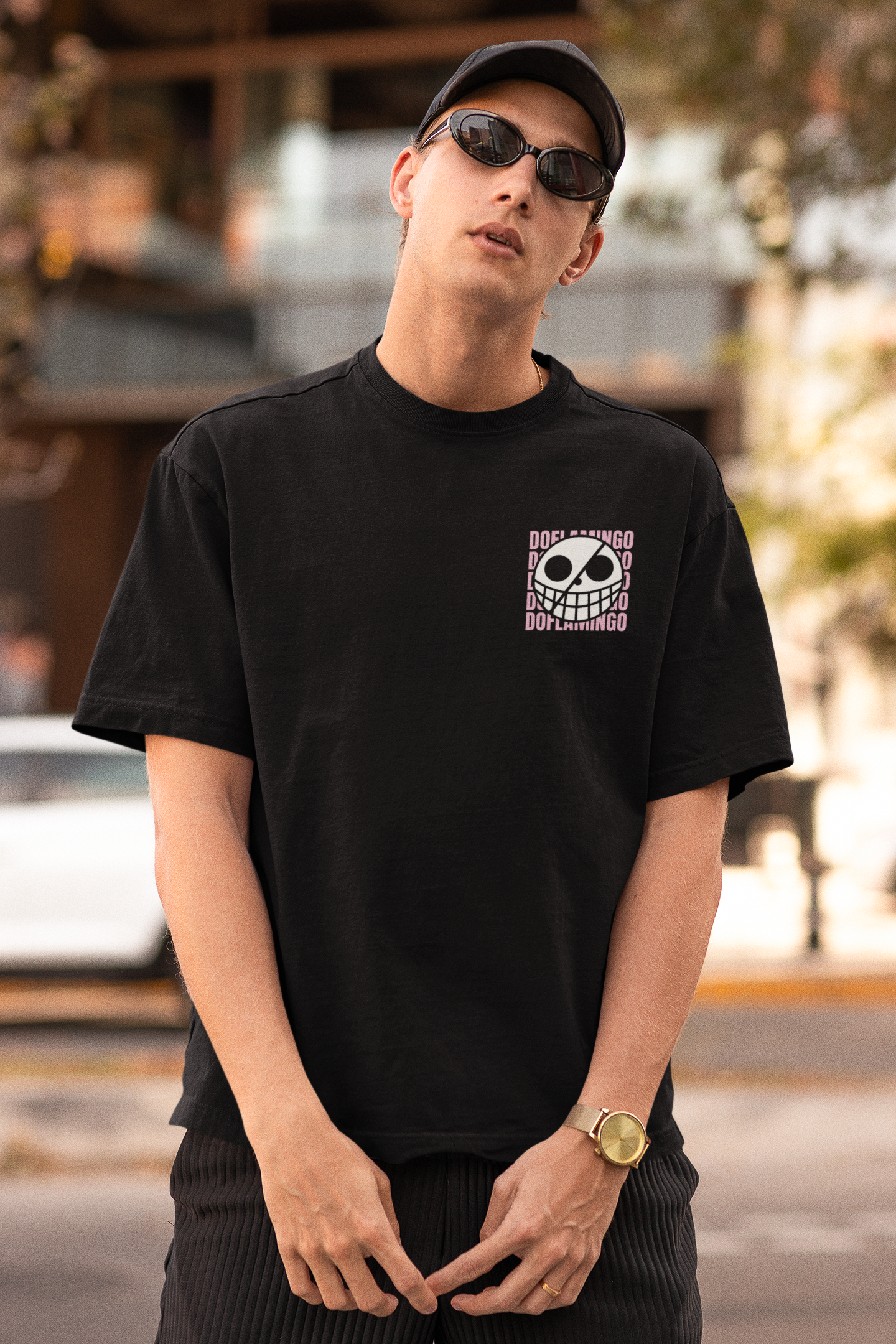 2nd front view of a male model wearing a black oversized t-shirt featuring Donquixote Doflamingo from the One Piece anime.