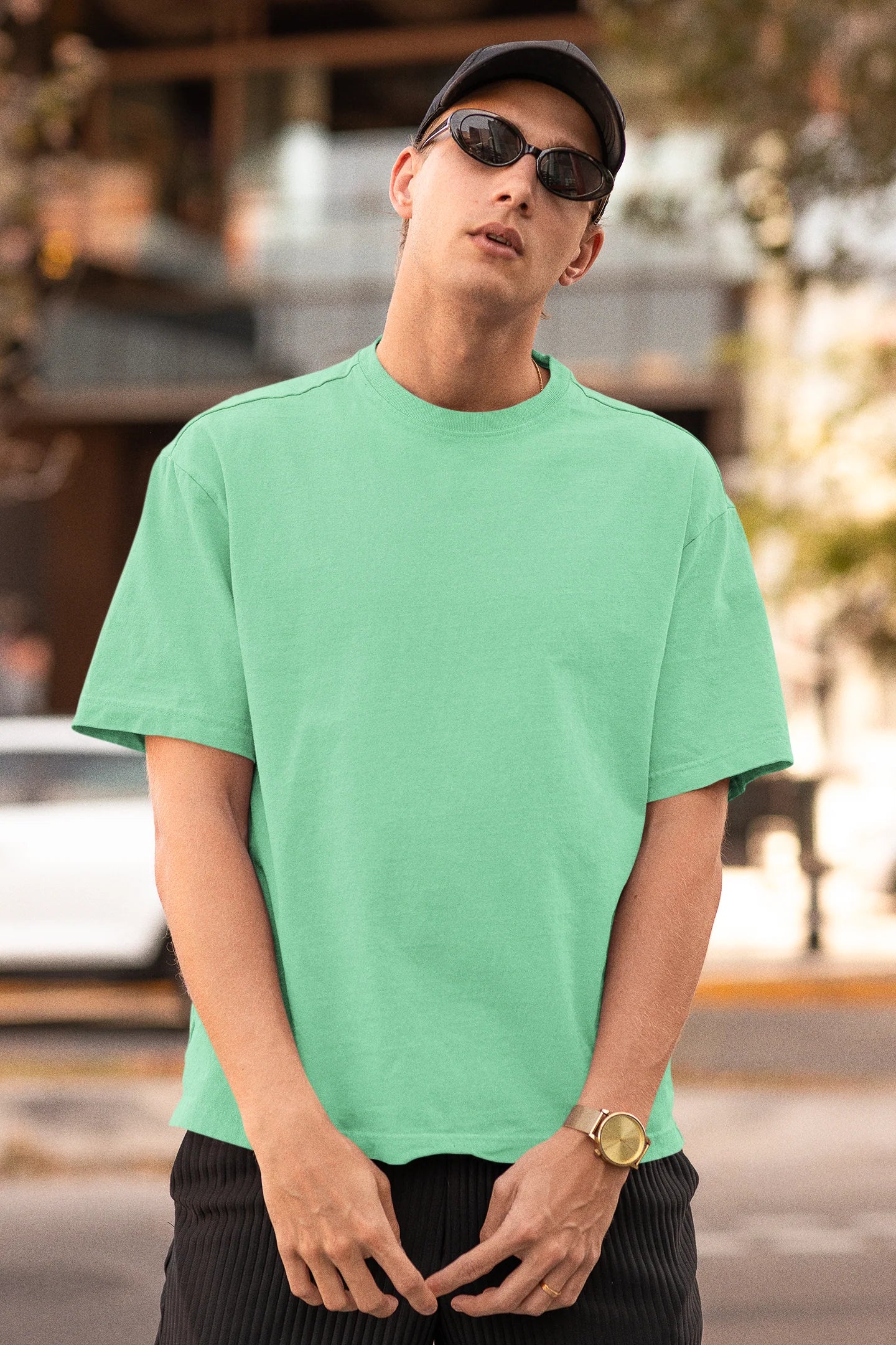 First front view of a male model wearing a mint green oversized t-shirt featuring Crocodile, the Desiccation Master, from the One Piece anime.