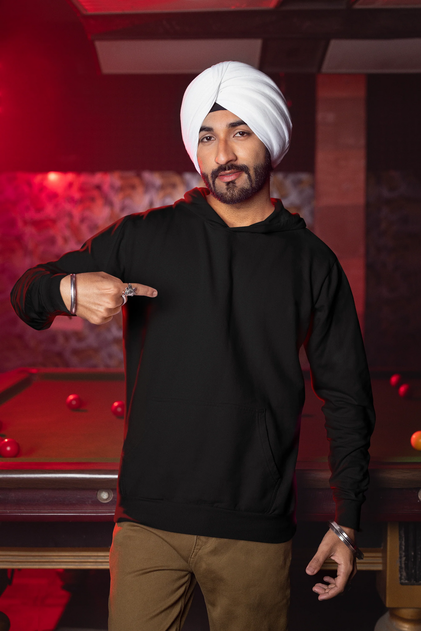 Second front view of a male model wearing a black hoodie with Diljit holding up a sunflower with the text "Dil Jeet" in the background.