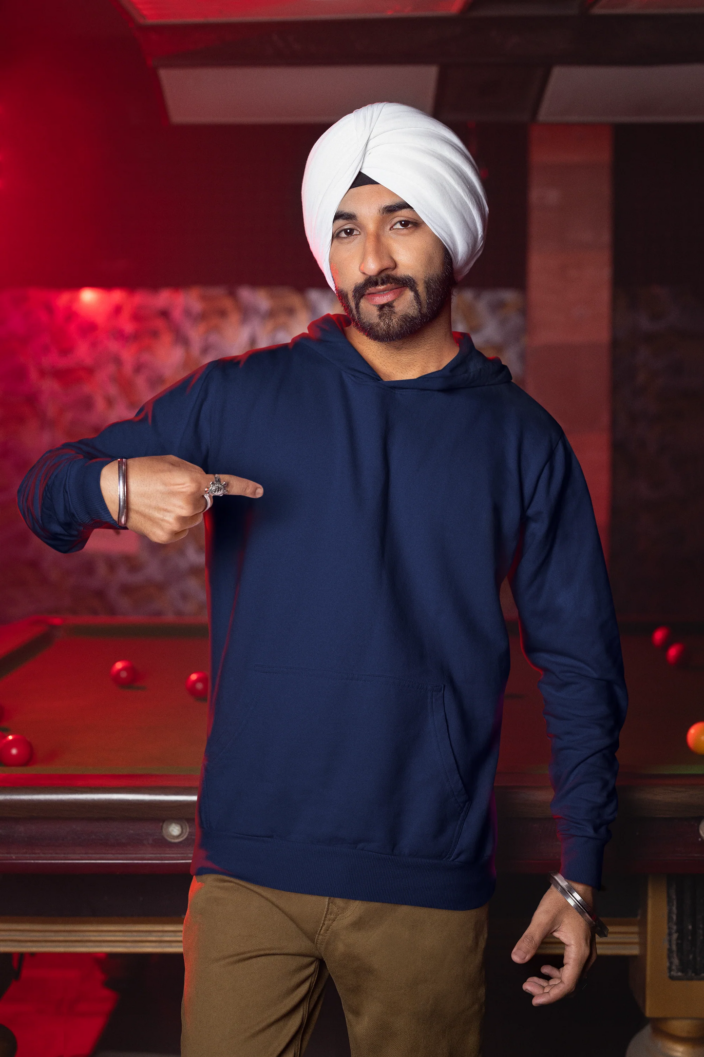 First front view of a male model wearing a royal blue hoodie with Diljit holding up a sunflower with the text "Dil Jeet" in the background.